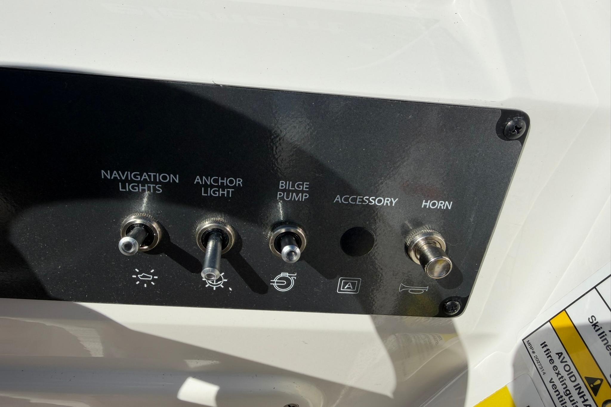 Control panel of 2026 Bayliner Element E18 with switches for lights, pump, and horn.