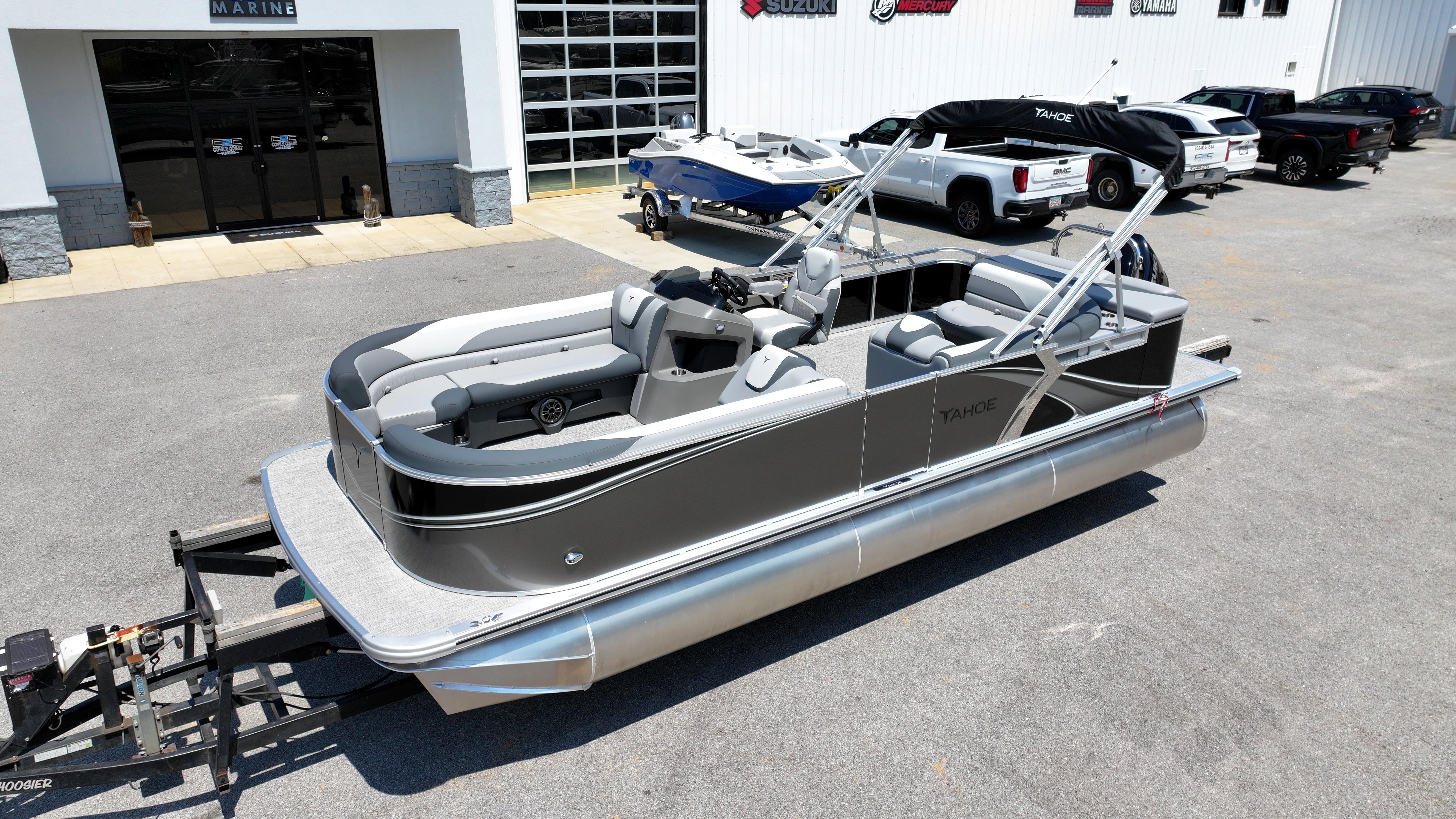 2025 Tahoe Pontoon LTZ Cruise boat on trailer outside dealership.