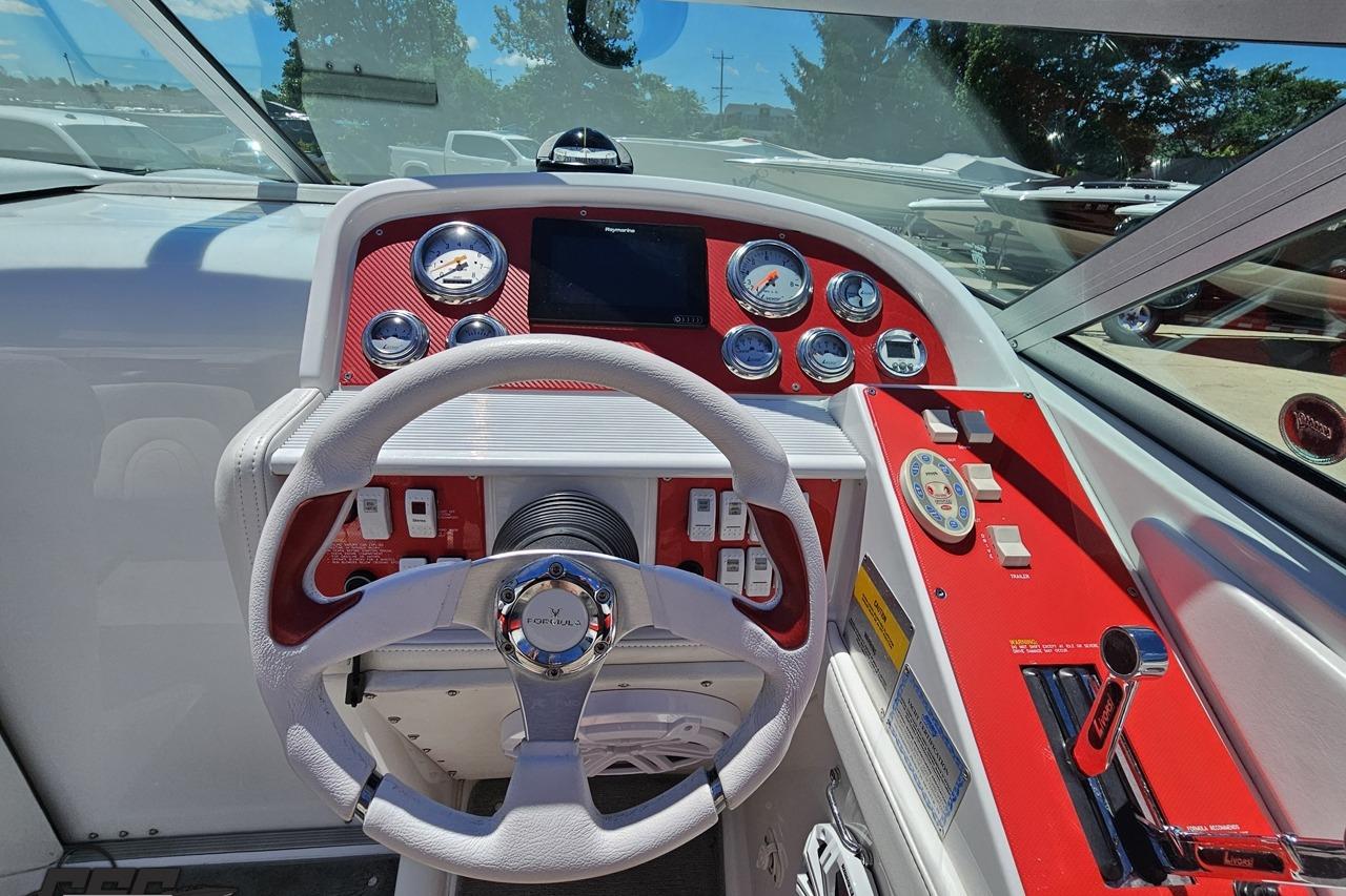 Dashboard of a 2005 Formula 271 FASTech boat with red accents and gauges.
