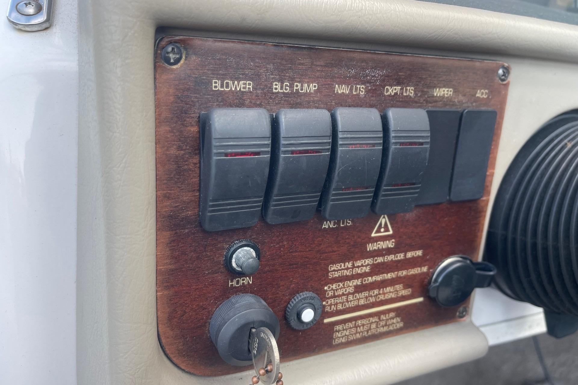 1996 Four Winns 200 Horizon dashboard with switches and warning labels.