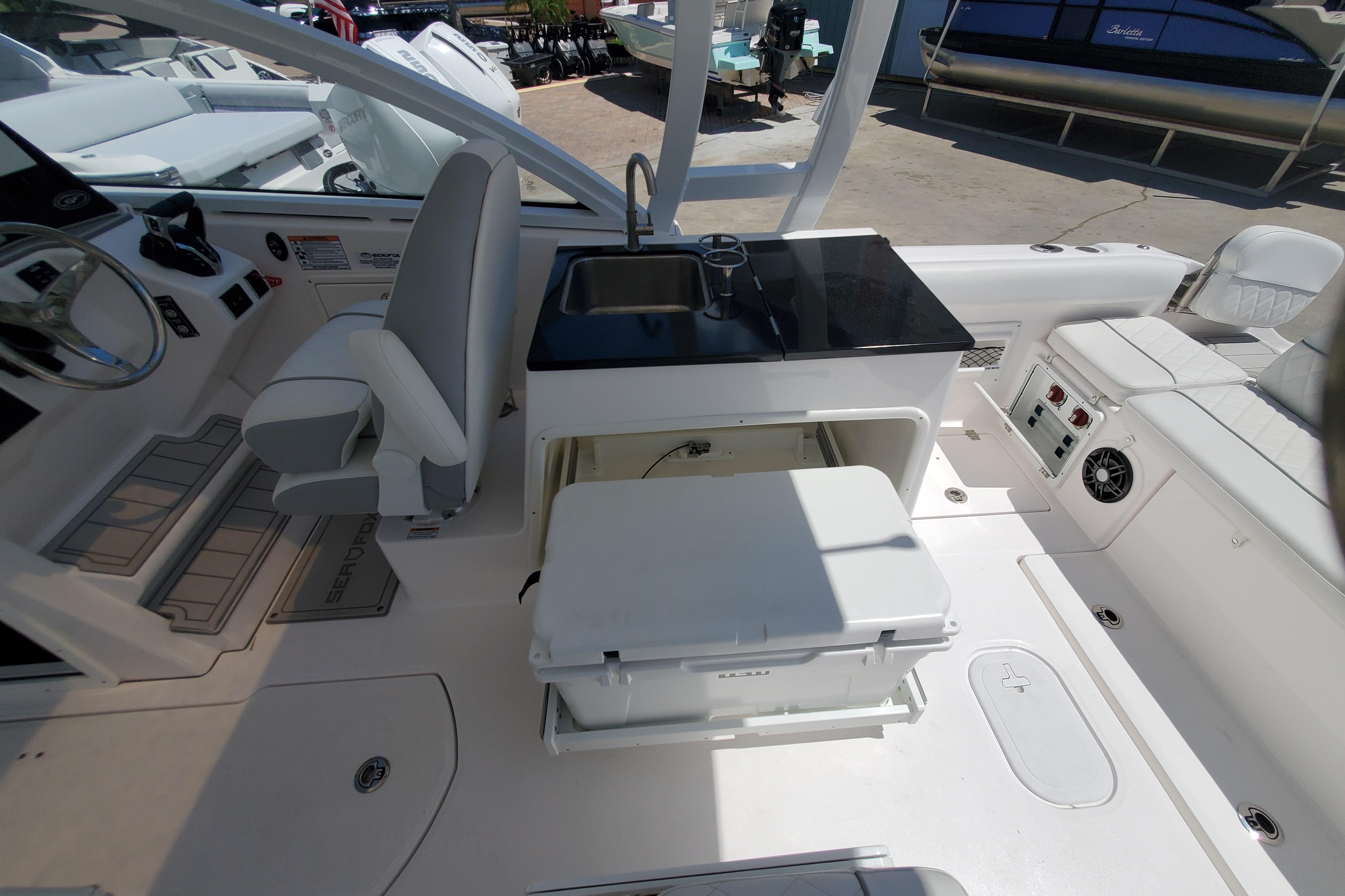 2024 Sea Fox 268 Traveler boat interior with seating, sink, and storage area.