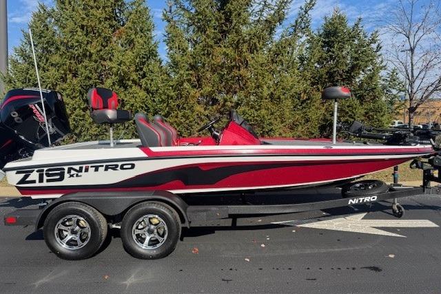2026 Nitro Z19 XL Pro boat, red and white, parked on a trailer.