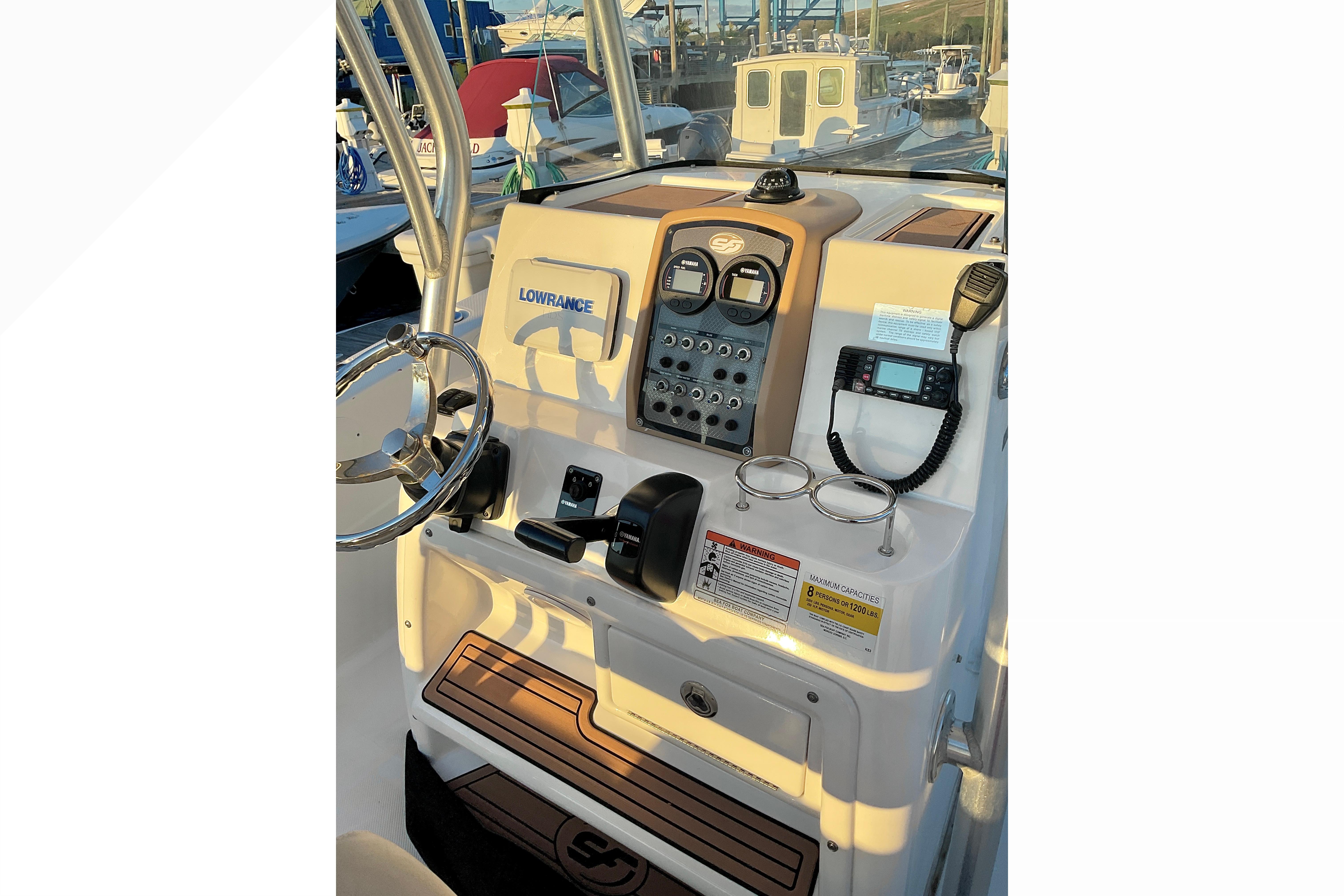 2016 Sea Fox 226 Commander boat console with steering wheel and navigation equipment.