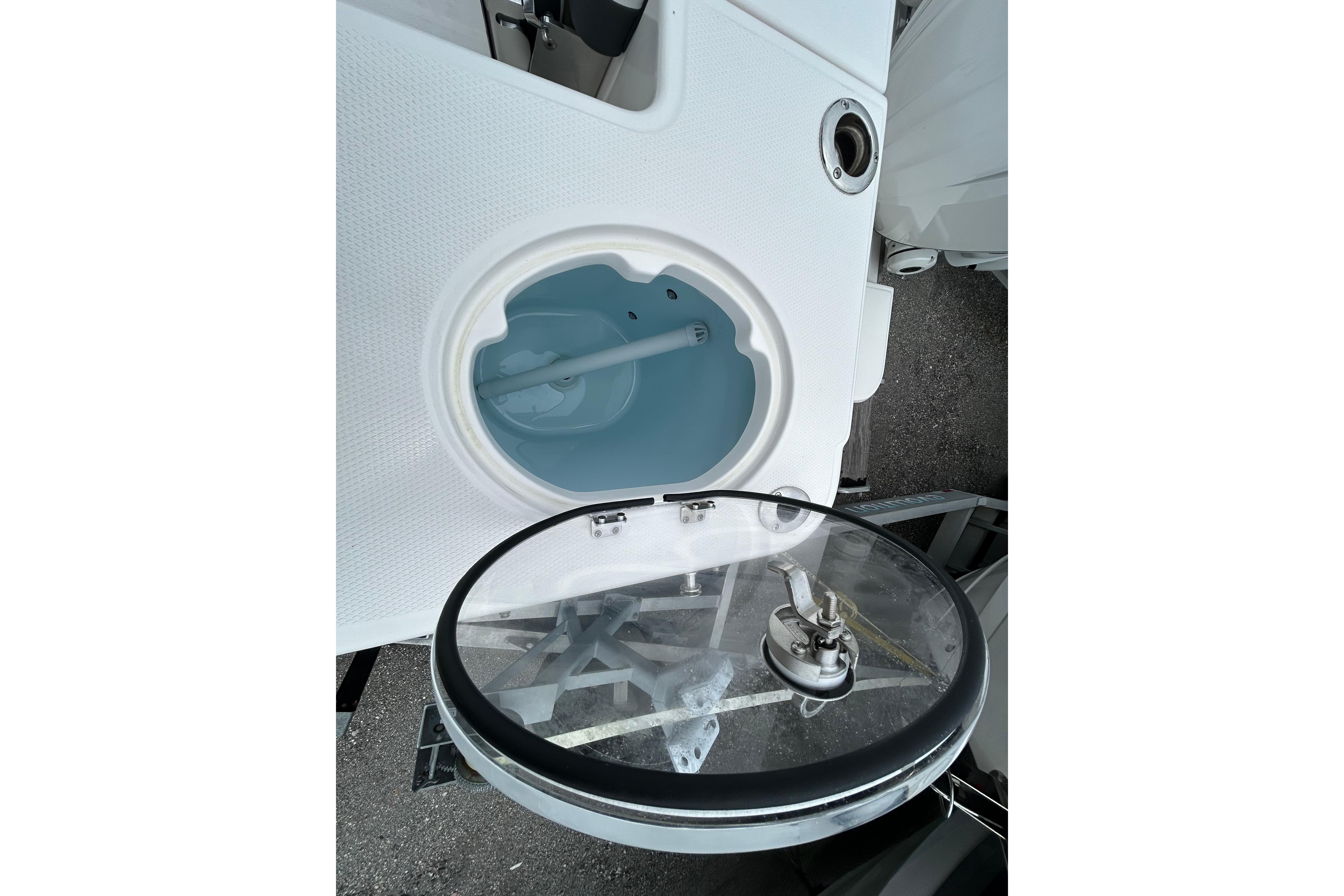 Livewell compartment on 2026 Robalo R277 Dual Console boat, open with clear lid.