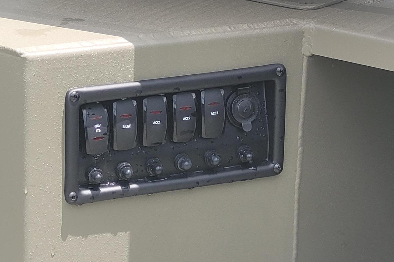 Control panel of 2026 Tracker Grizzly 1650 T Prairie Wings Edition boat with switches.