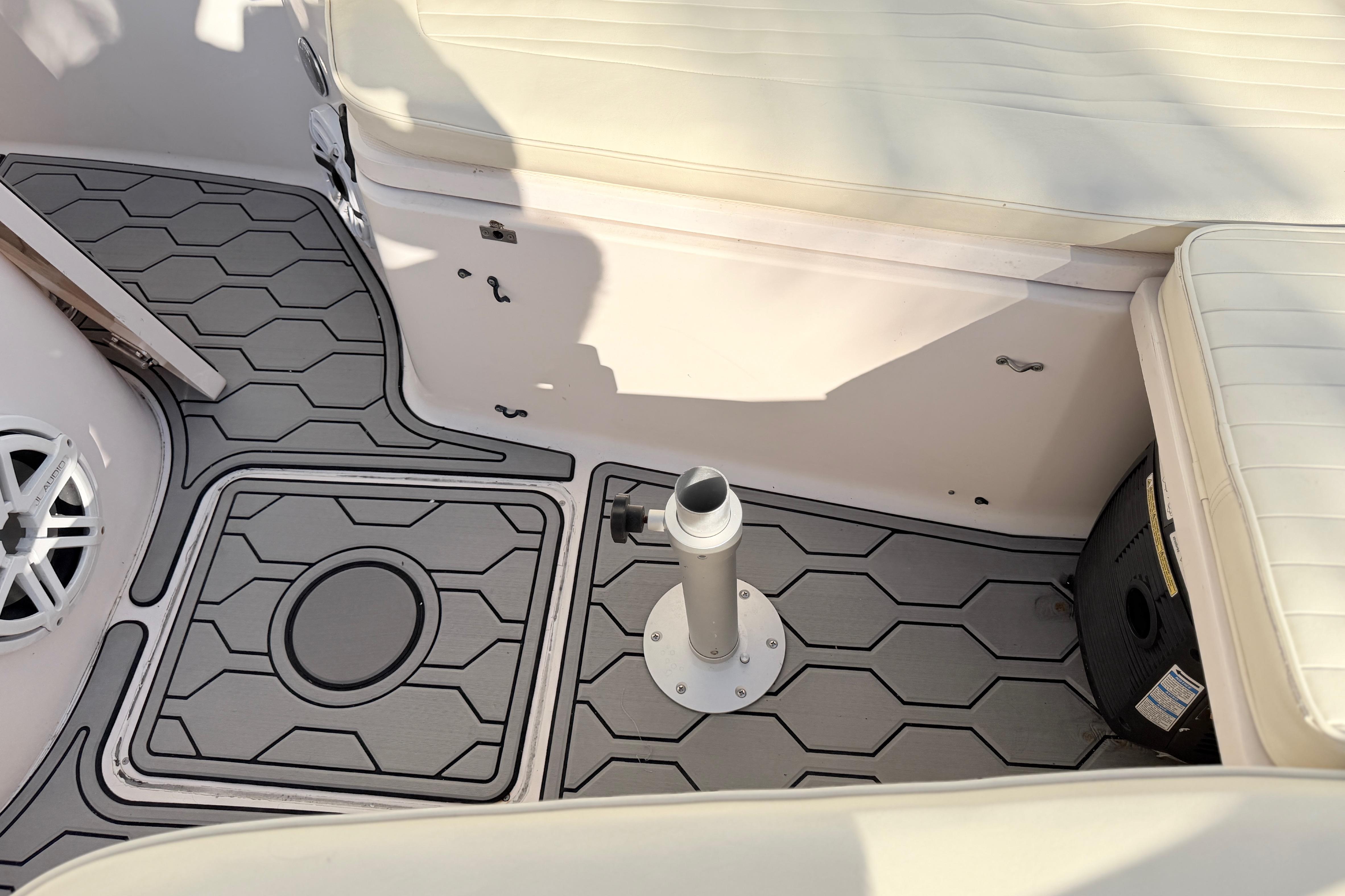 2004 Grady White 273 boat interior with hexagonal patterned flooring and cushioned seating.