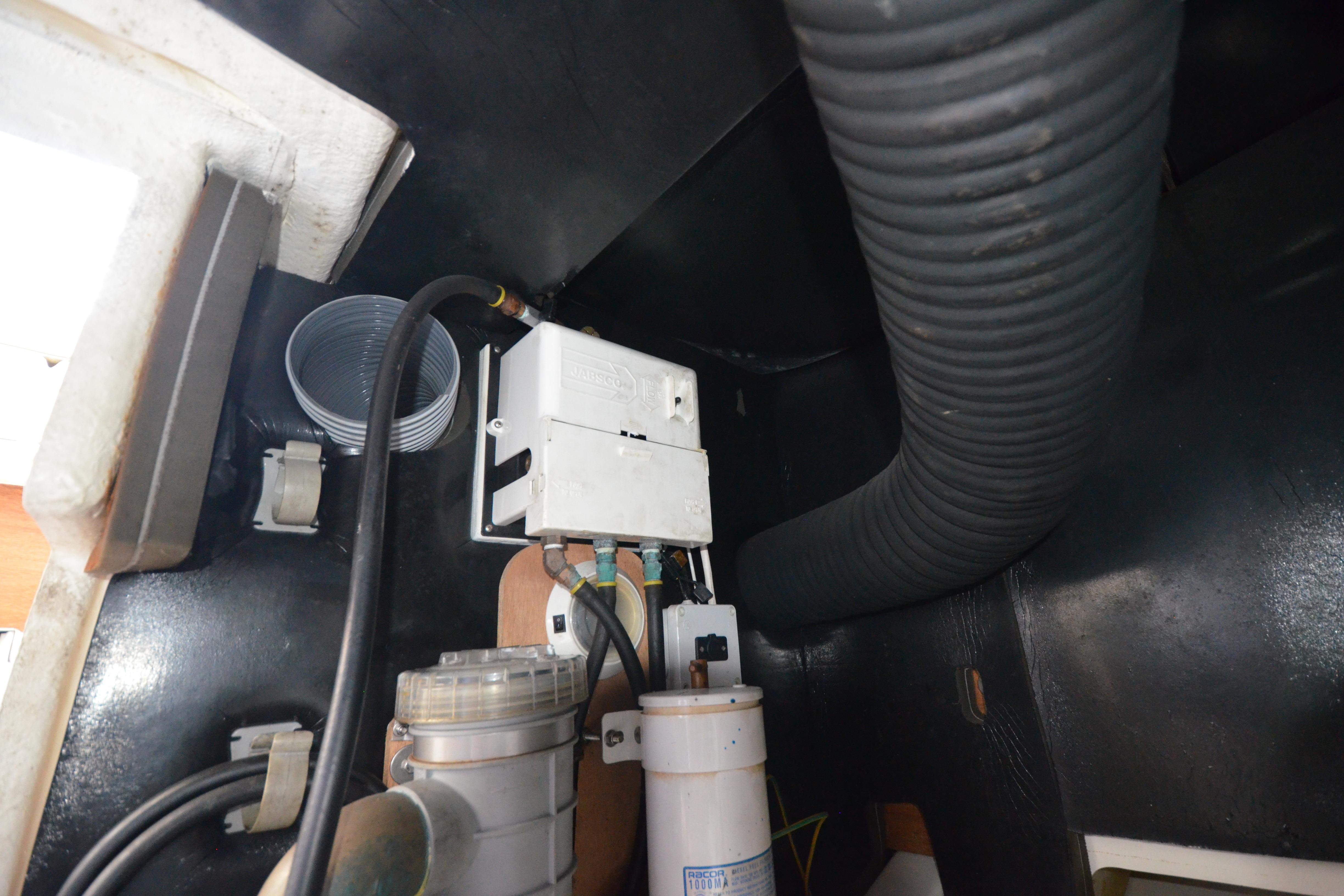 Engine compartment of 2007 Jeanneau Prestige 46 yacht, showing hoses and electrical components.