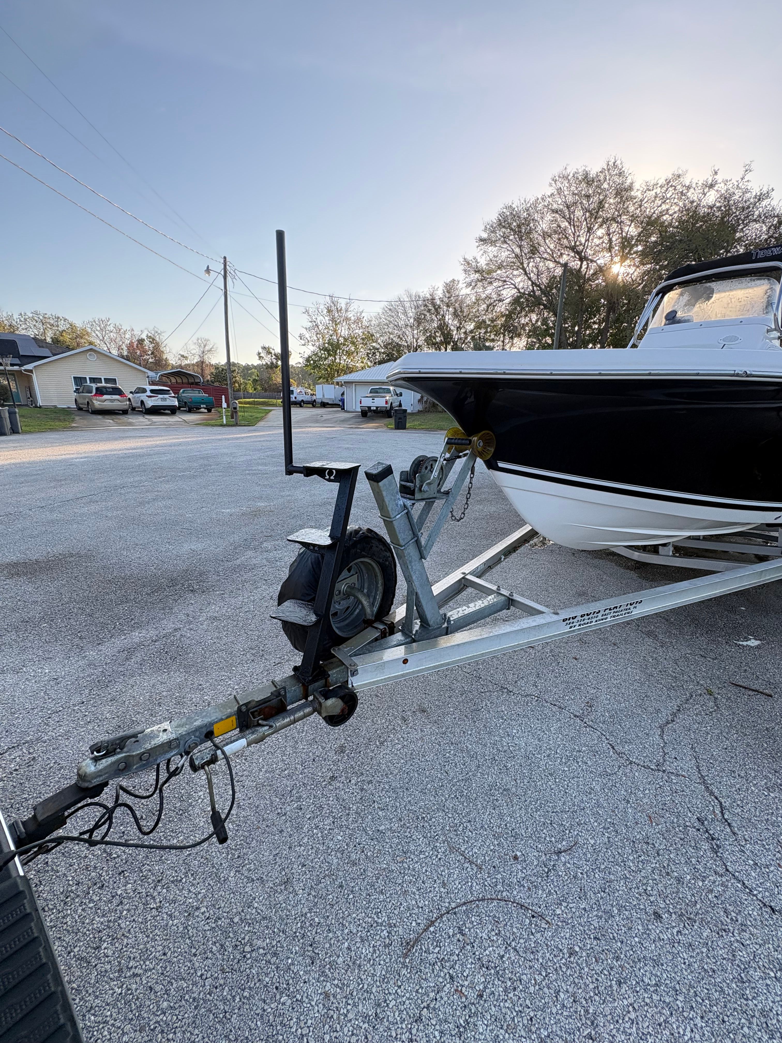 A 2024 Tidewater 198 CC Adventure on a trailer in a parking lot.
