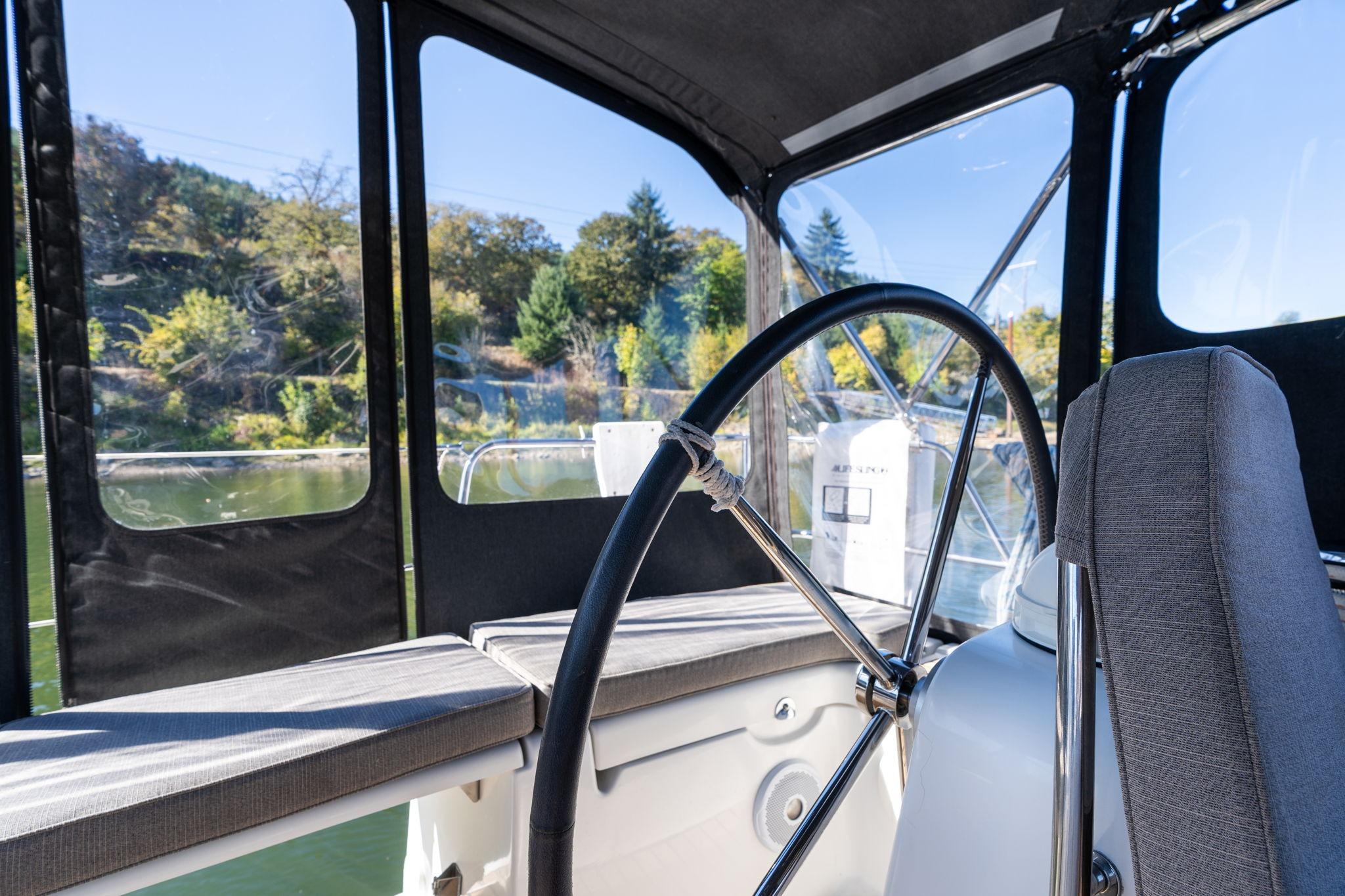 Cockpit view of 2013 Beneteau Oceanis 50 sailboat with steering wheel and seating.