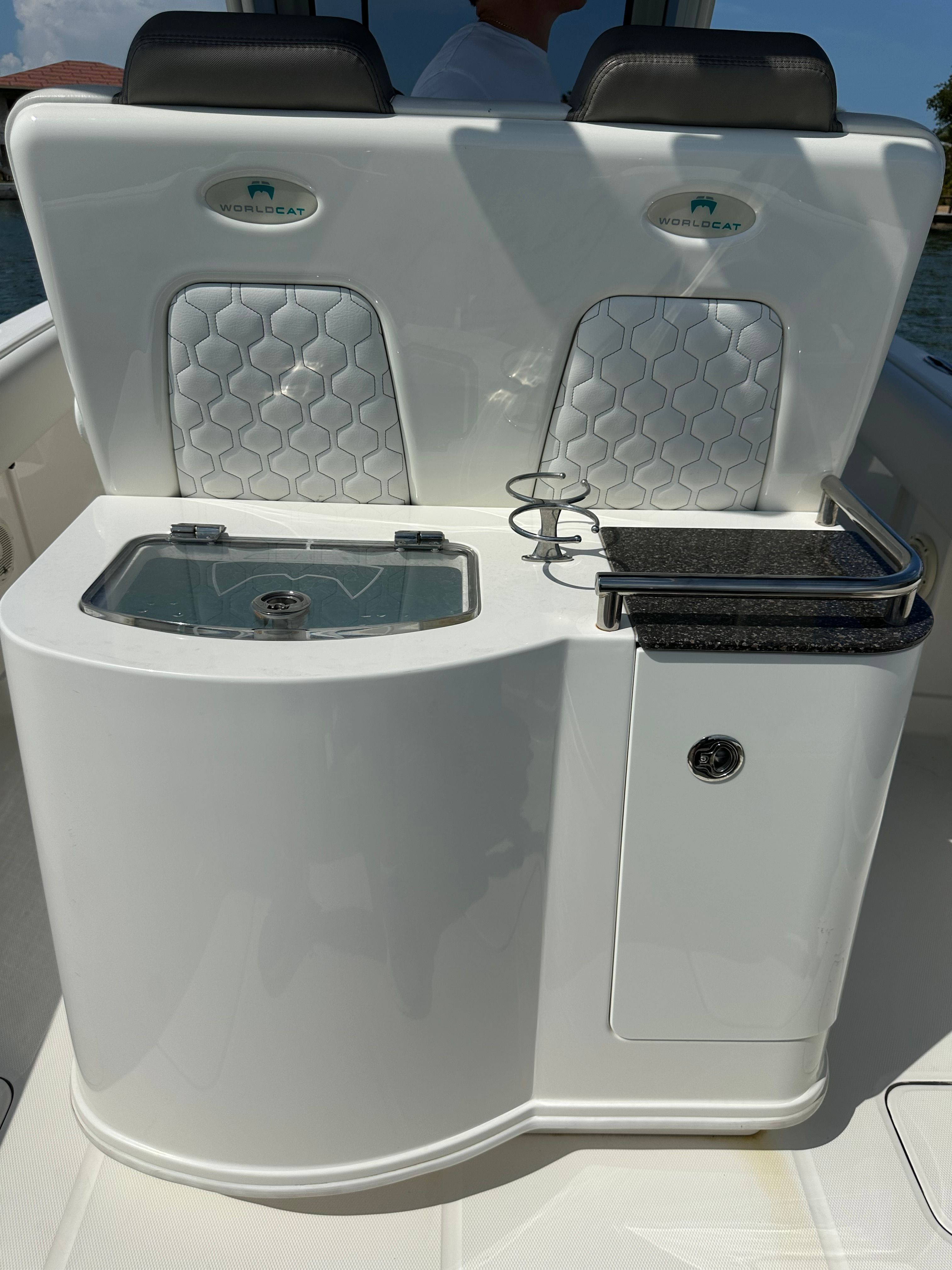 The image shows the cockpit of a 2020 World Cat 280 CC-X with sleek seating and a sink.