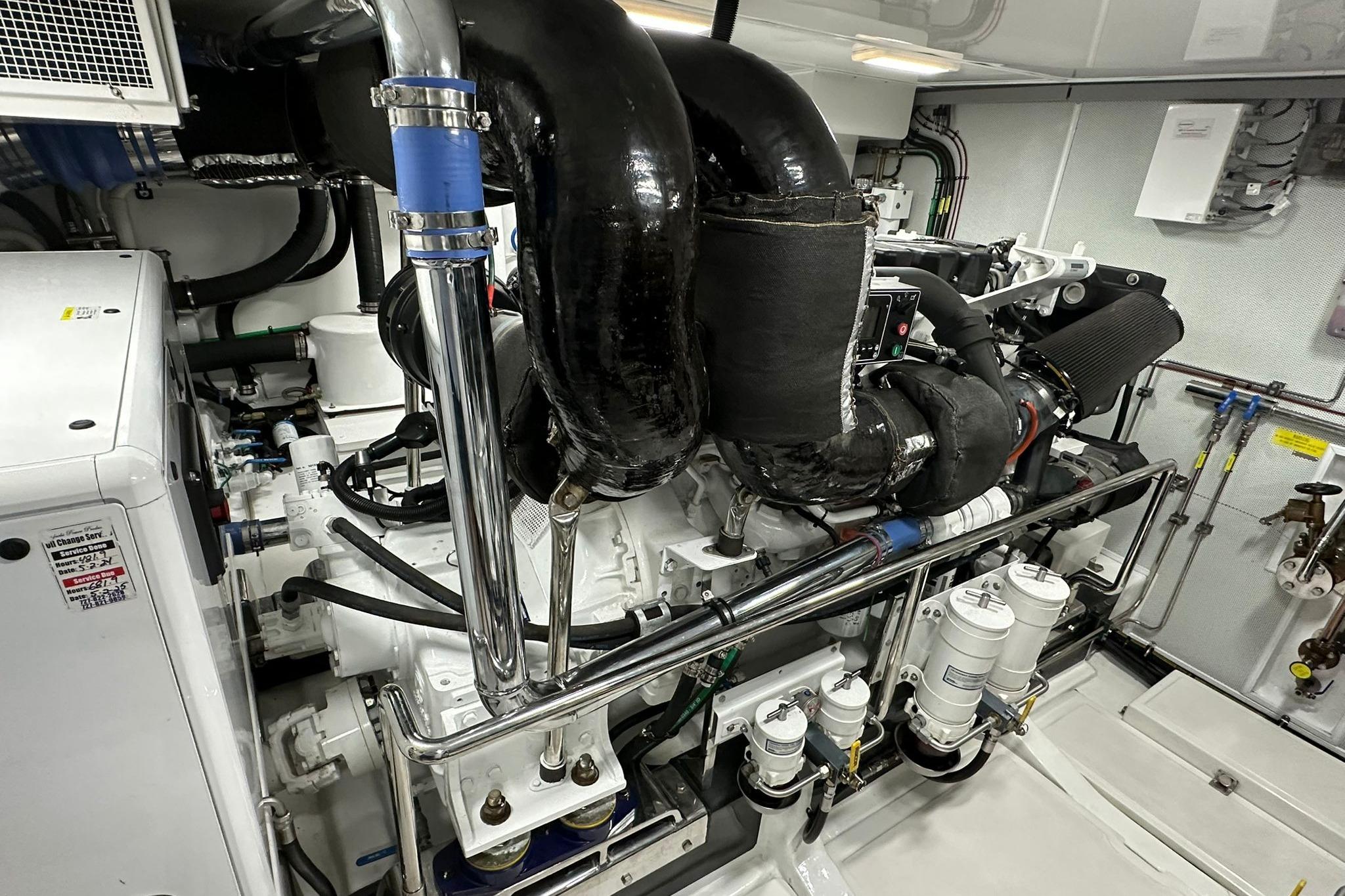 Engine room of 2023 Marlow Explorer 66E-CB yacht, showcasing advanced machinery and components.