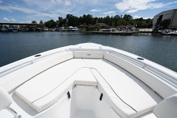 2024 Sea Hunt Ultra 234 boat bow seating area on a calm lake.