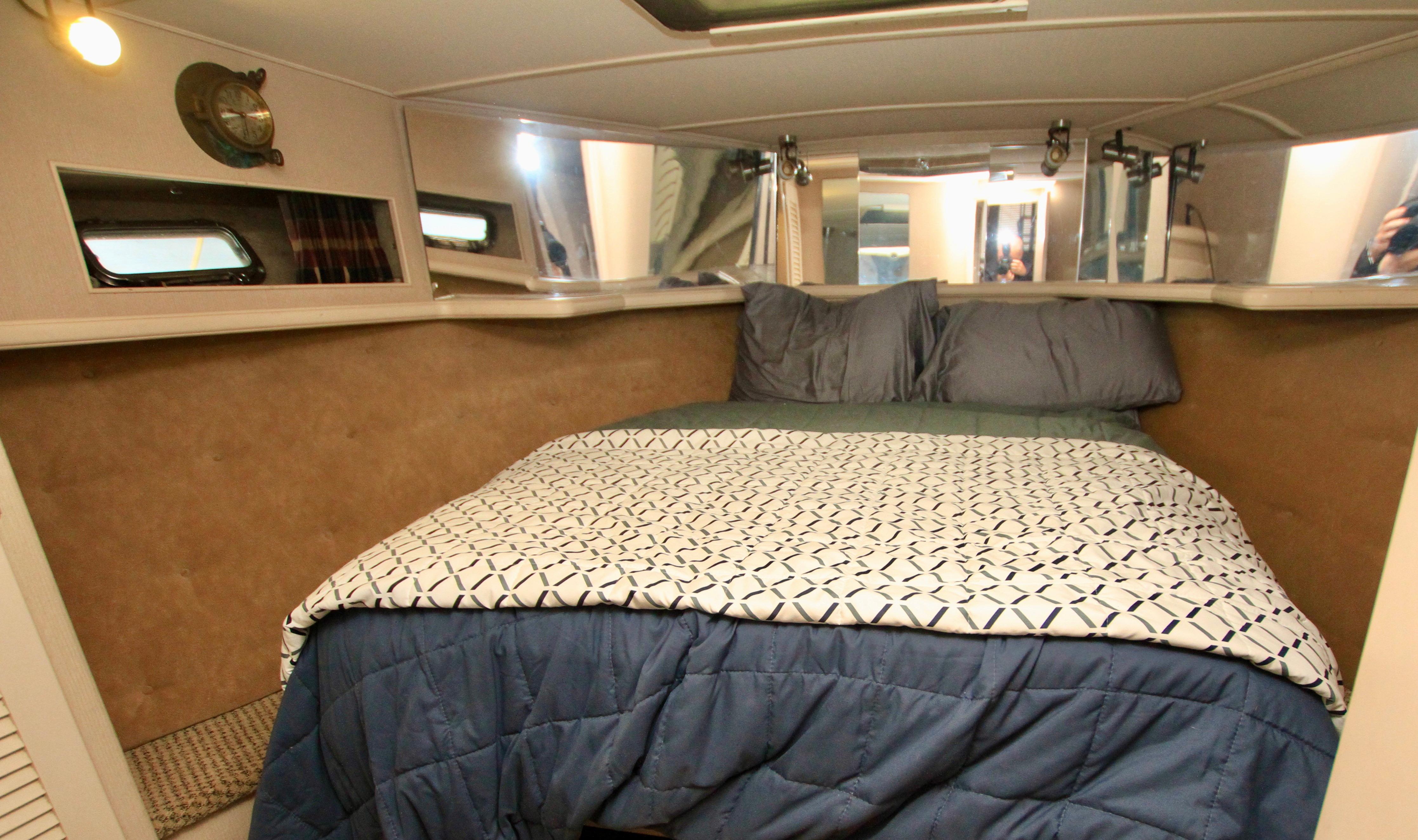 1989 Tollycraft 34 Sport Sedan cabin with cozy bed and nautical decor.