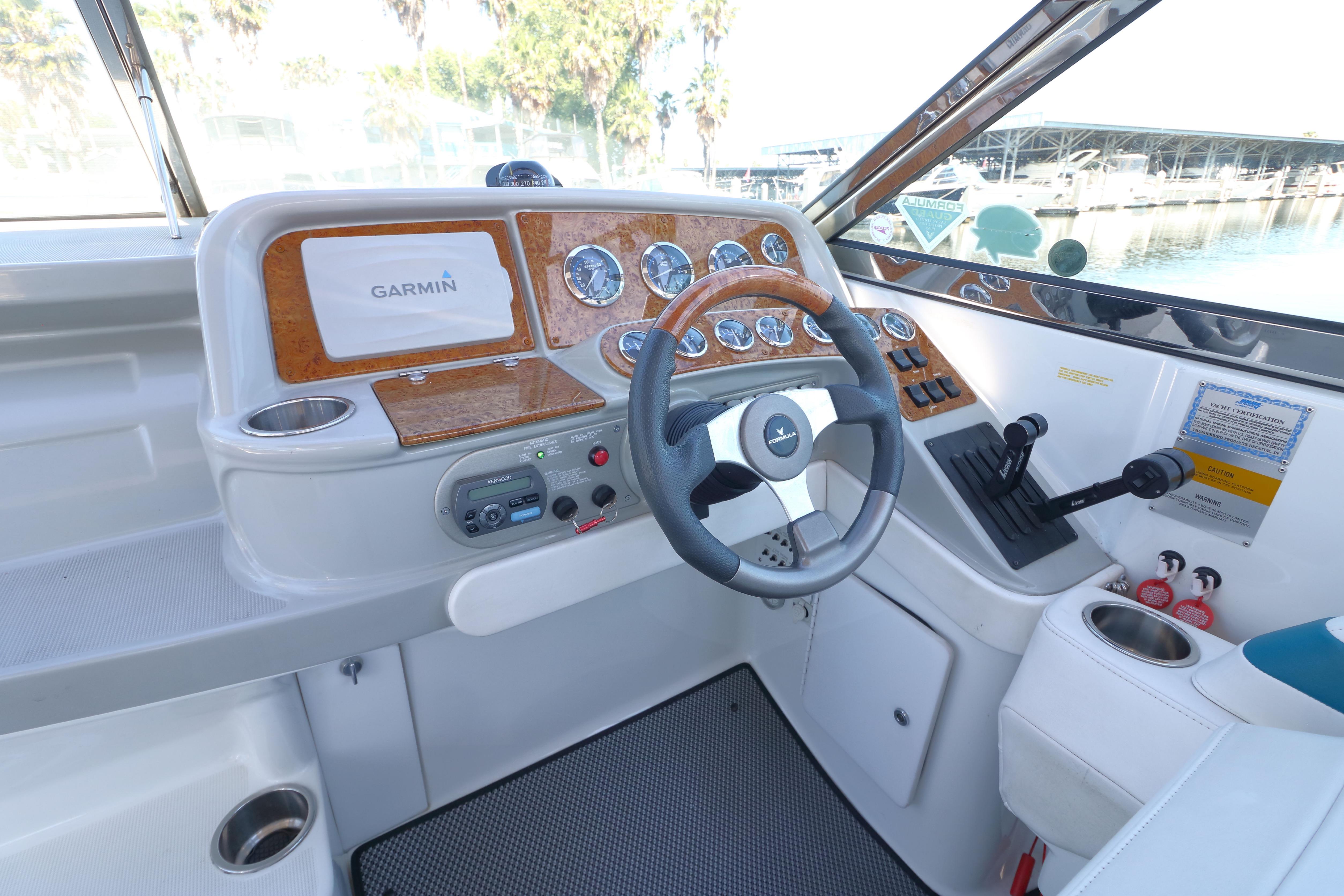 Interior cockpit of 2006 Formula 330 Sun Sport boat with Garmin navigation system.