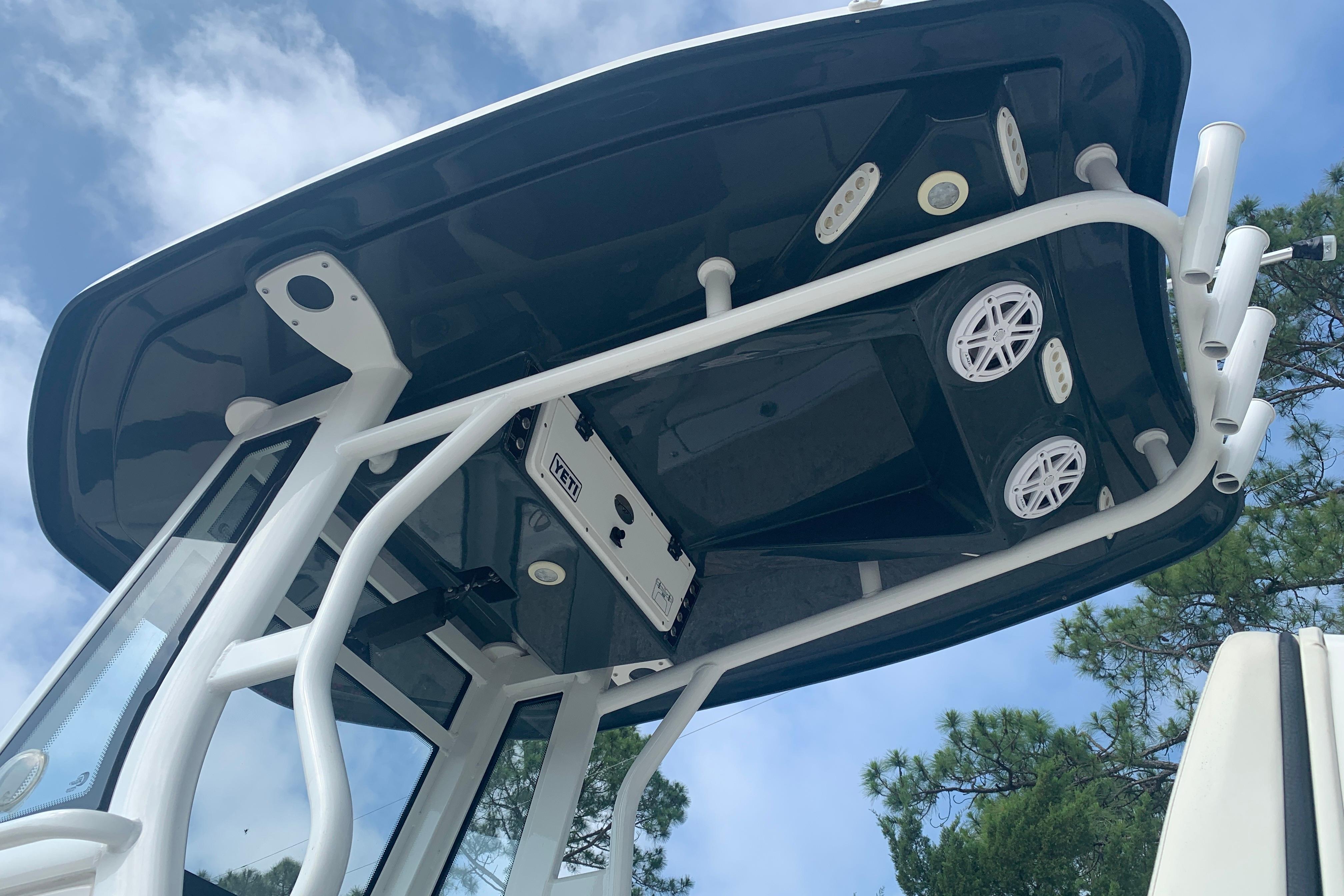 2021 Tidewater 256 CC Adventure boat T-top with speakers and rod holders.