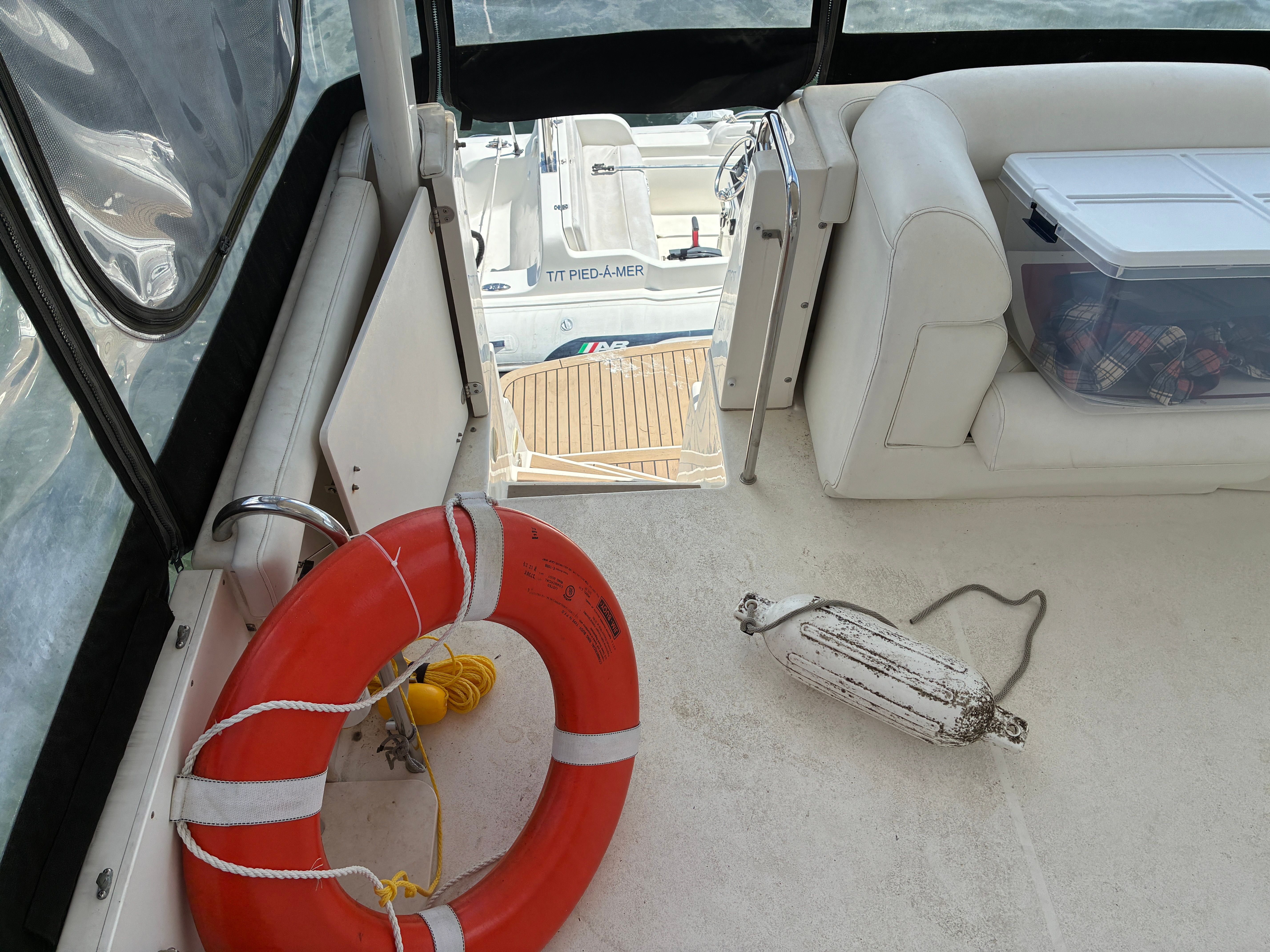 The image shows the deck of a 2001 Silverton 392 Motor Yacht with a lifebuoy and fender.