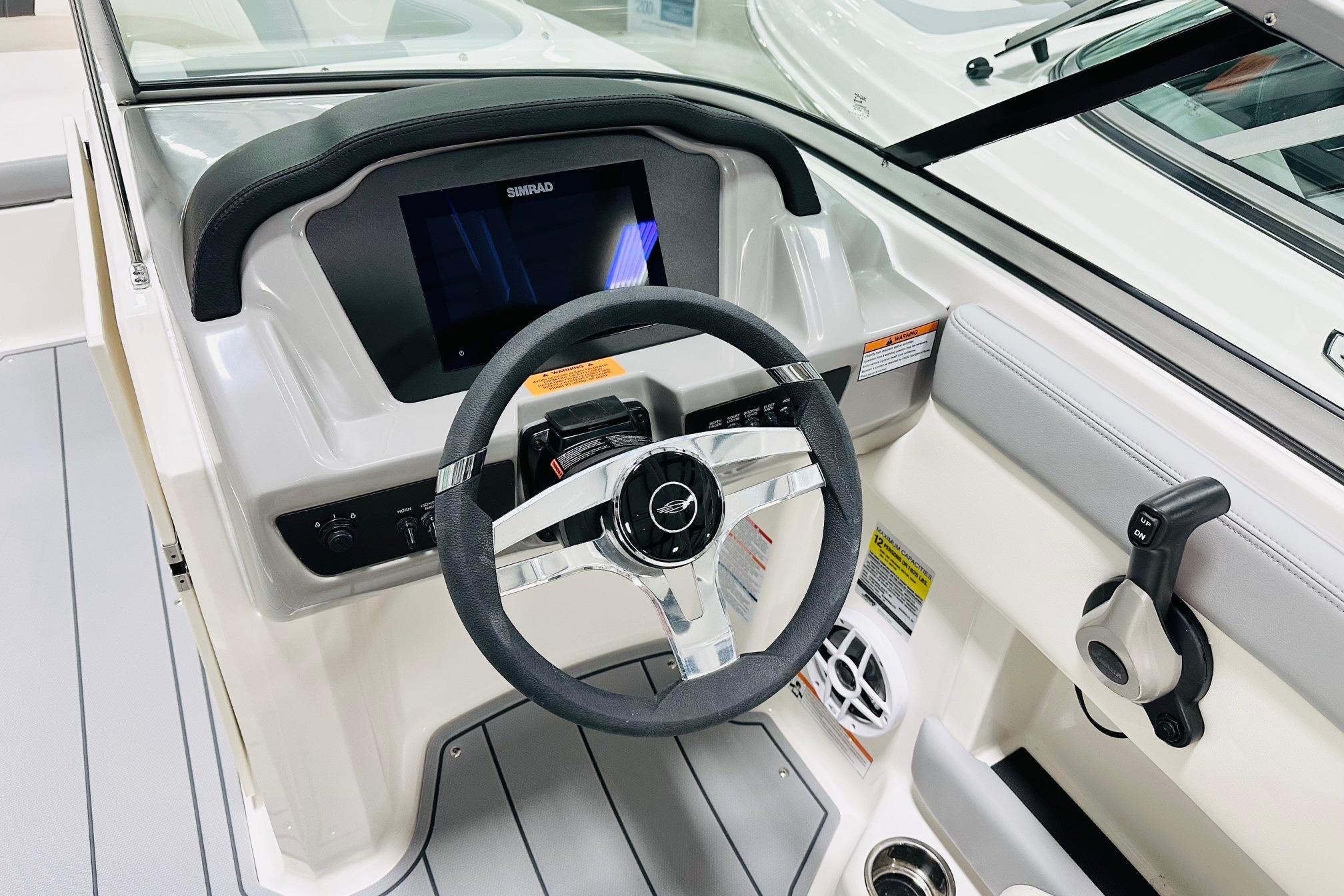 2025 Chaparral 21 SSi OB boat dashboard with steering wheel and control panel.