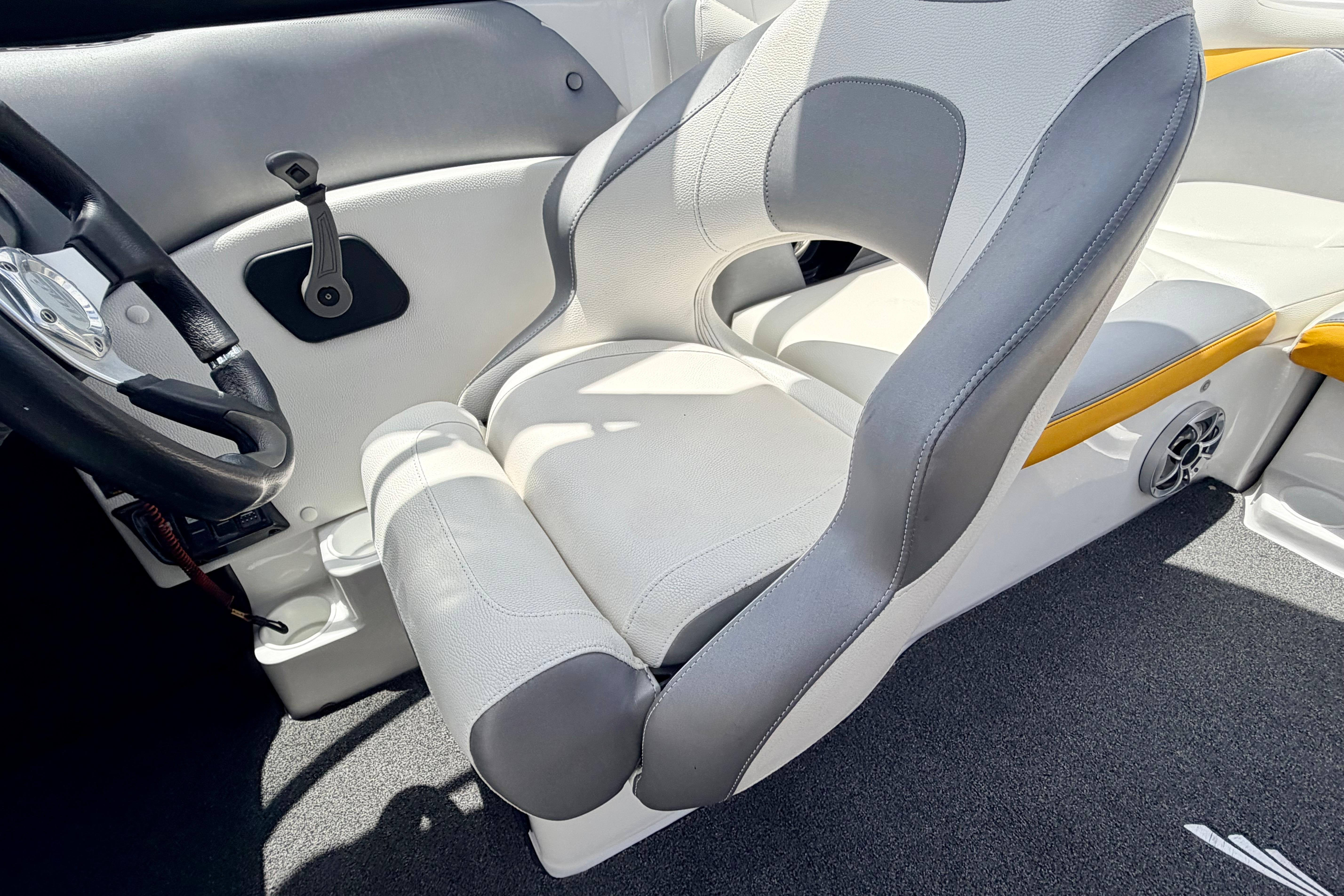 2014 Tigé R20 boat interior with gray and white seating, steering wheel, and speaker.