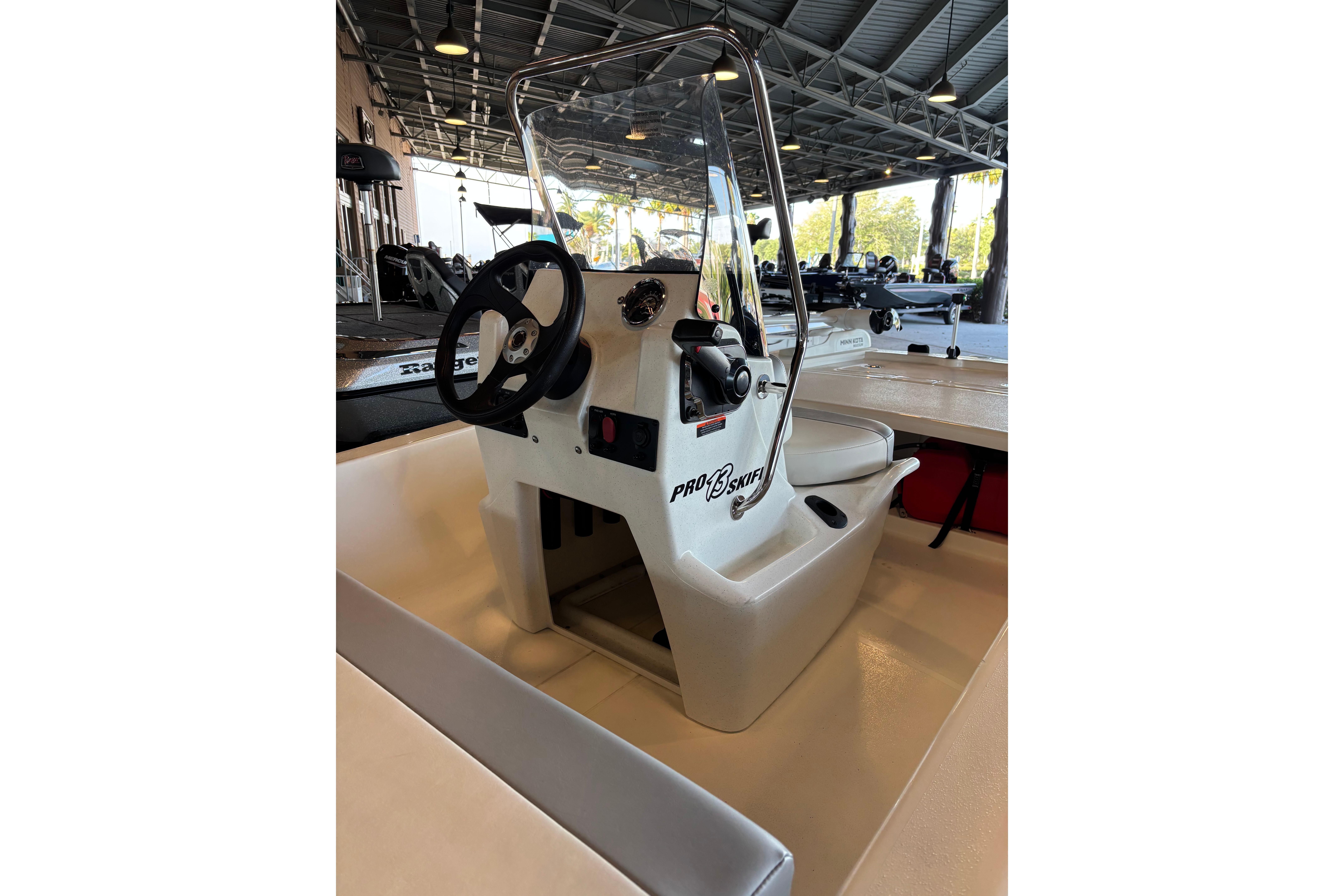 2026 Mako Pro Skiff 13 CC boat interior with steering wheel and console.