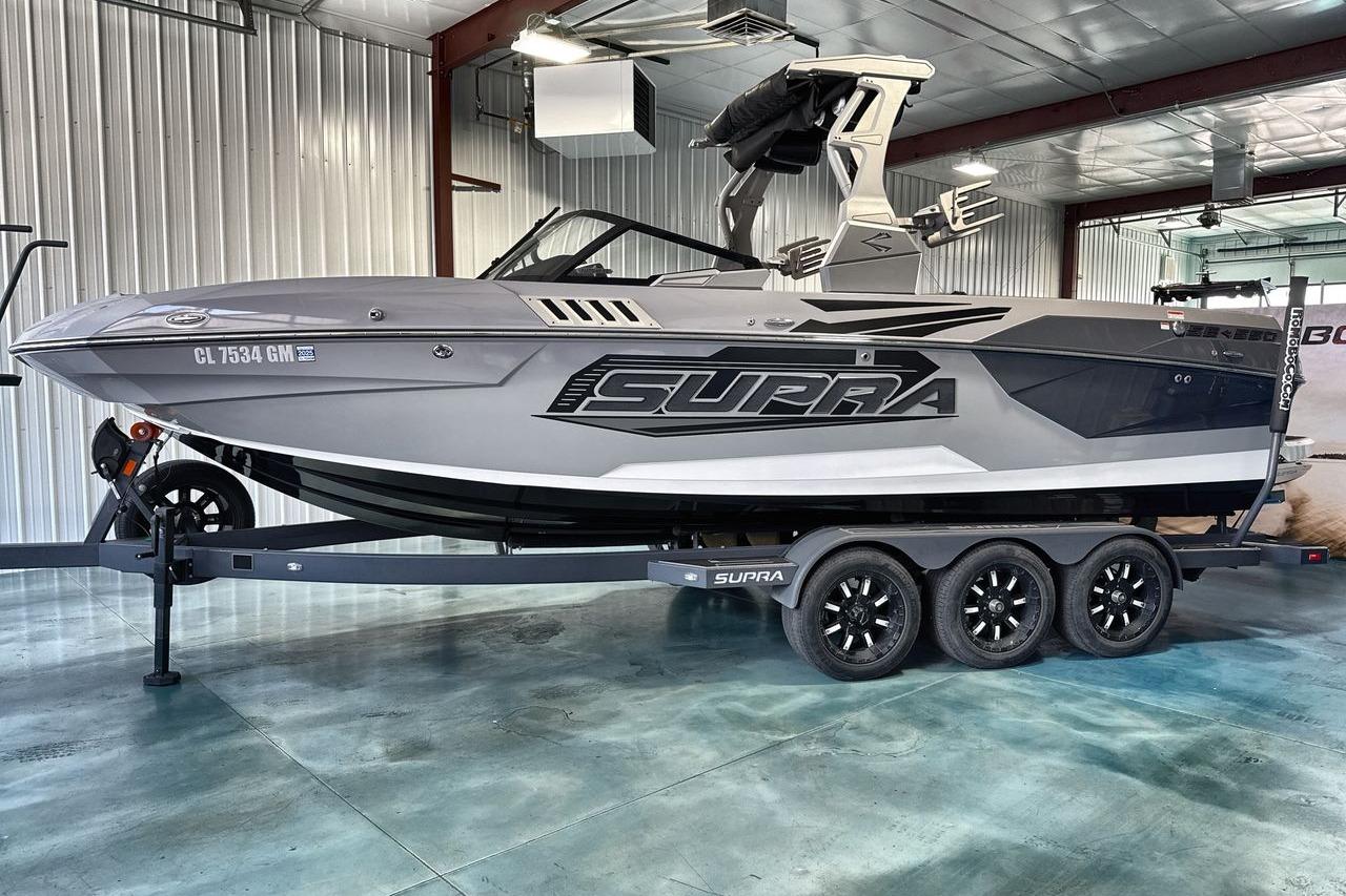 2021 Supra SE 550 boat on trailer in a modern indoor facility.
