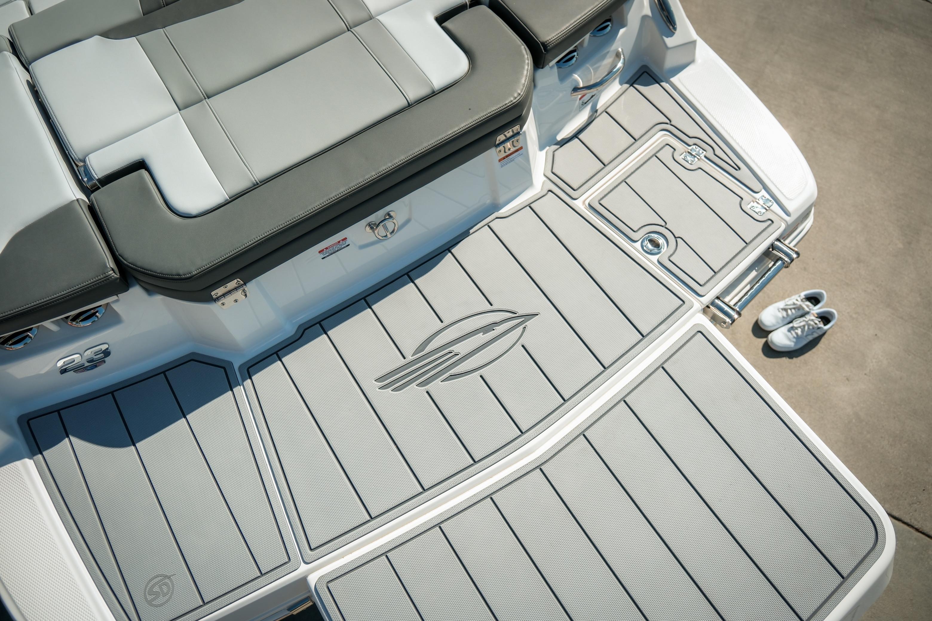 2026 Chaparral 23 SSi boat deck with cushioned seating and stylish flooring design.