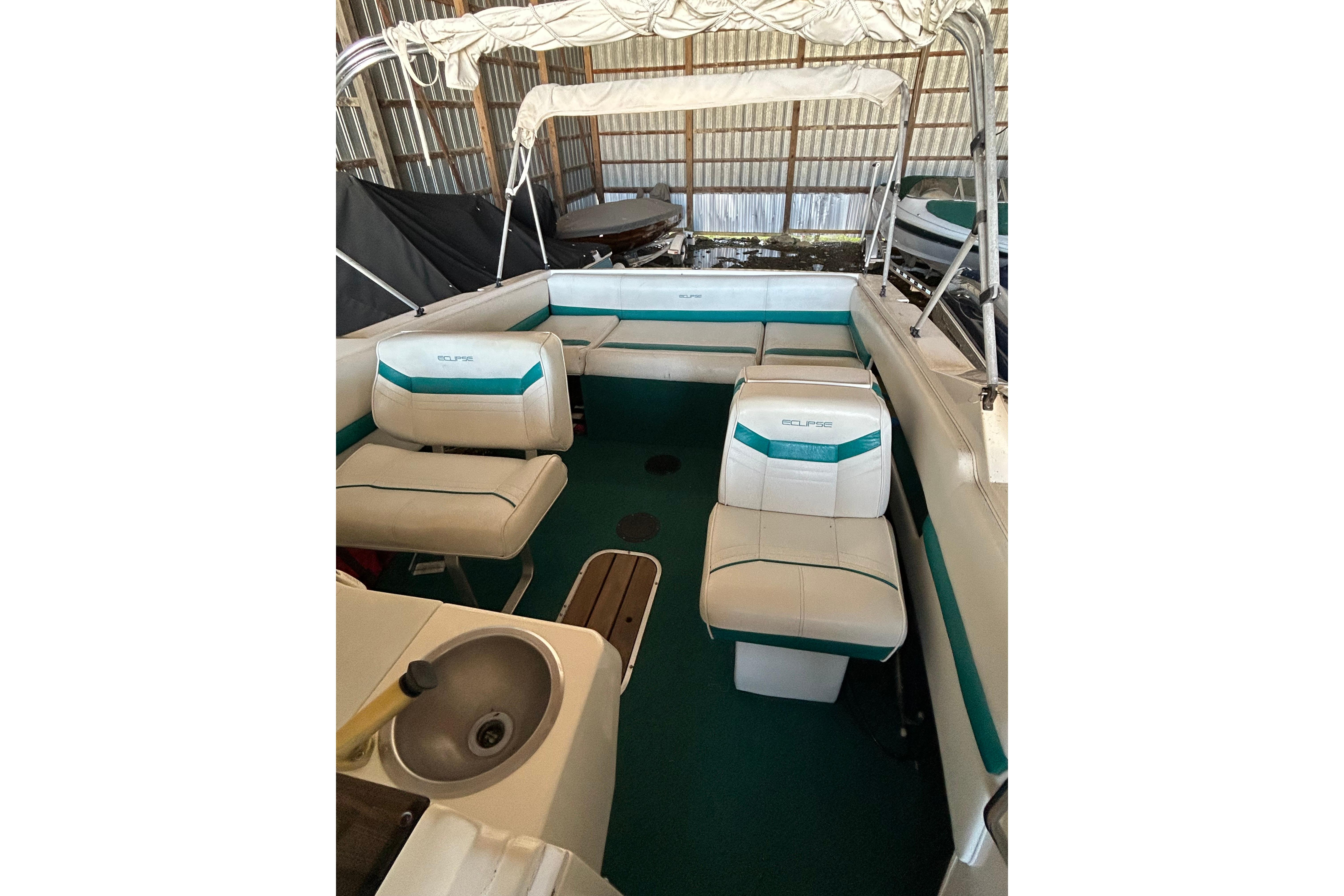 Interior of a 1991 Wellcraft 232 Eclipse boat with seating and canopy.