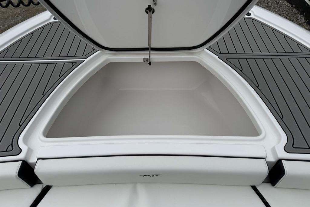 Open storage compartment on 2026 Tidewater 2500 Carolina Bay boat, featuring sleek design.