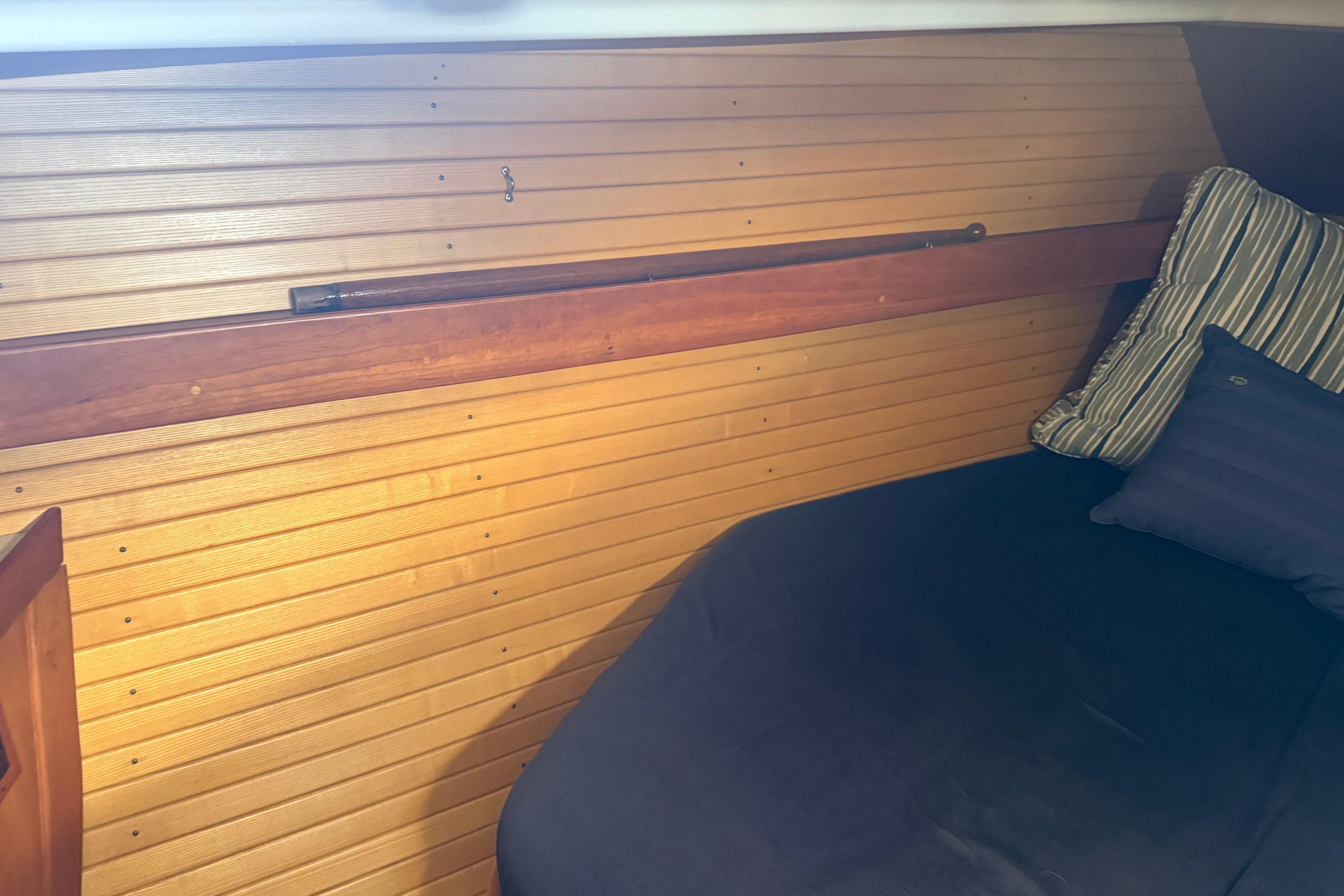 Interior cabin of a 2004 Sabre 386 sailboat with wooden paneling and cushions.