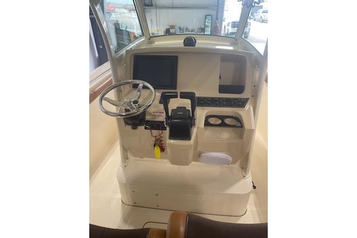 2015 Scout 255 LXF boat dashboard with steering wheel and control panel.