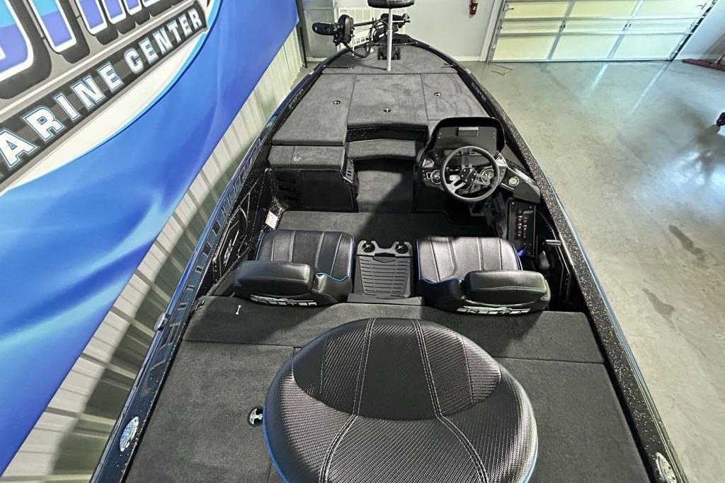 2026 Skeeter ZX200 boat interior with steering wheel and seating, displayed in a showroom.