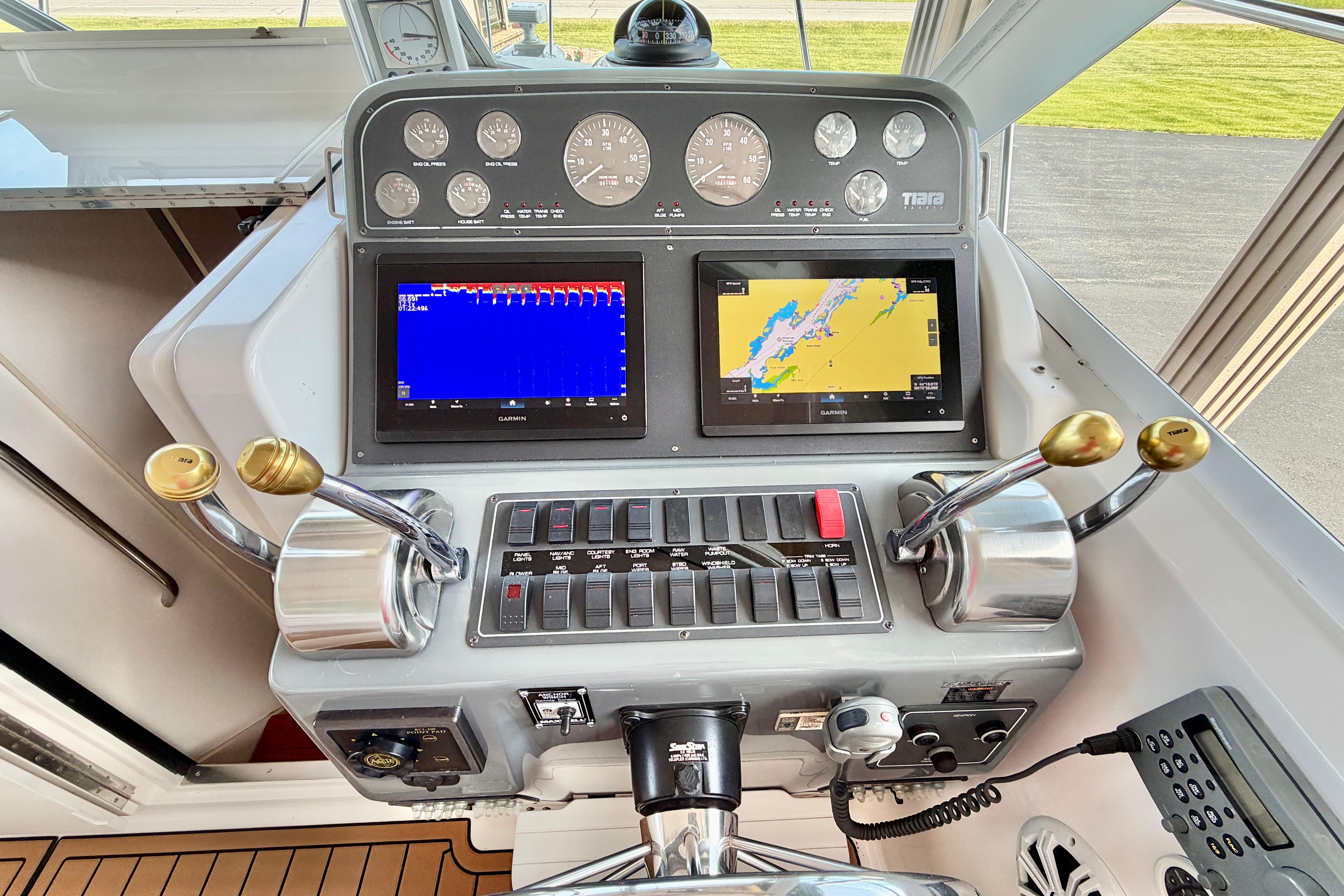Control panel of a 1999 Tiara Yachts 2900 Coronet with navigation screens and gauges.