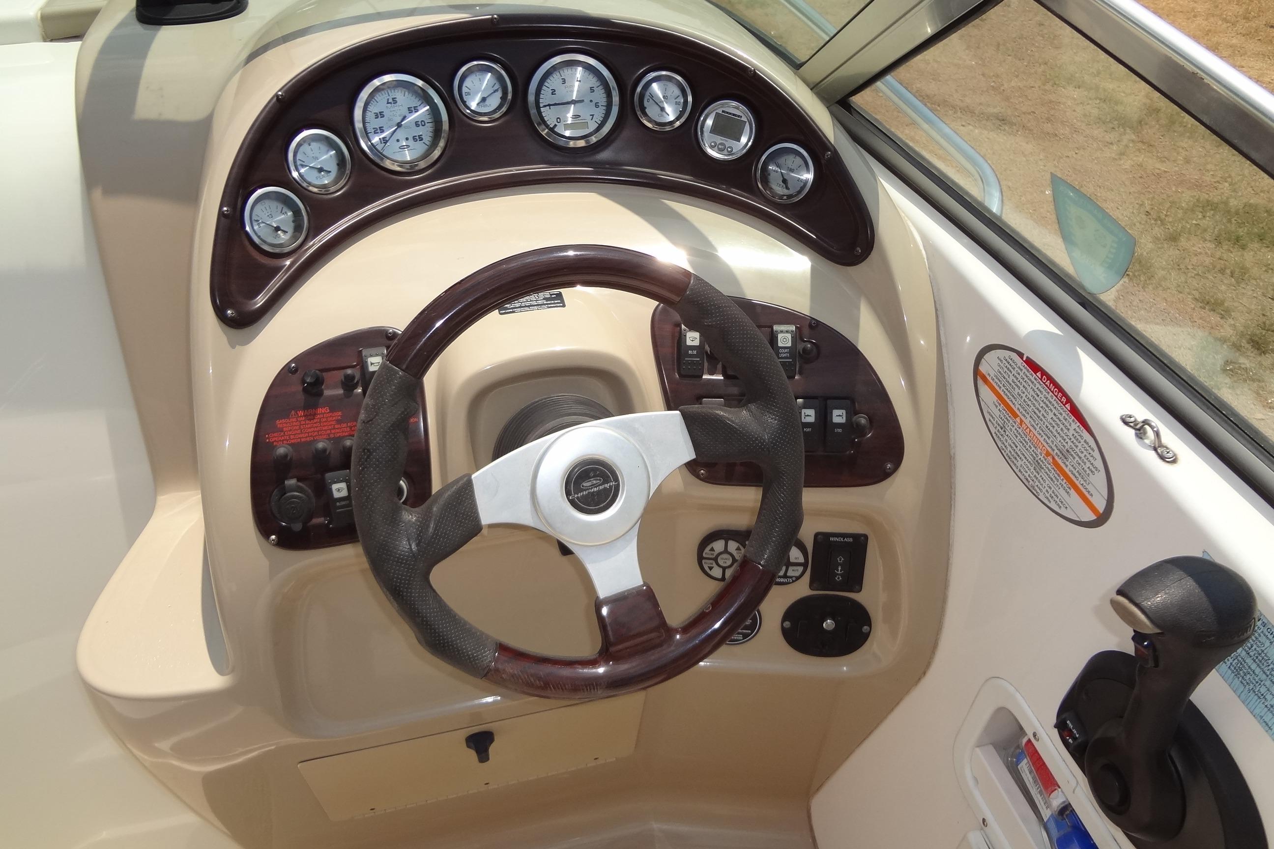Steering console of 2000 Chaparral Signature 260 boat with gauges and controls.