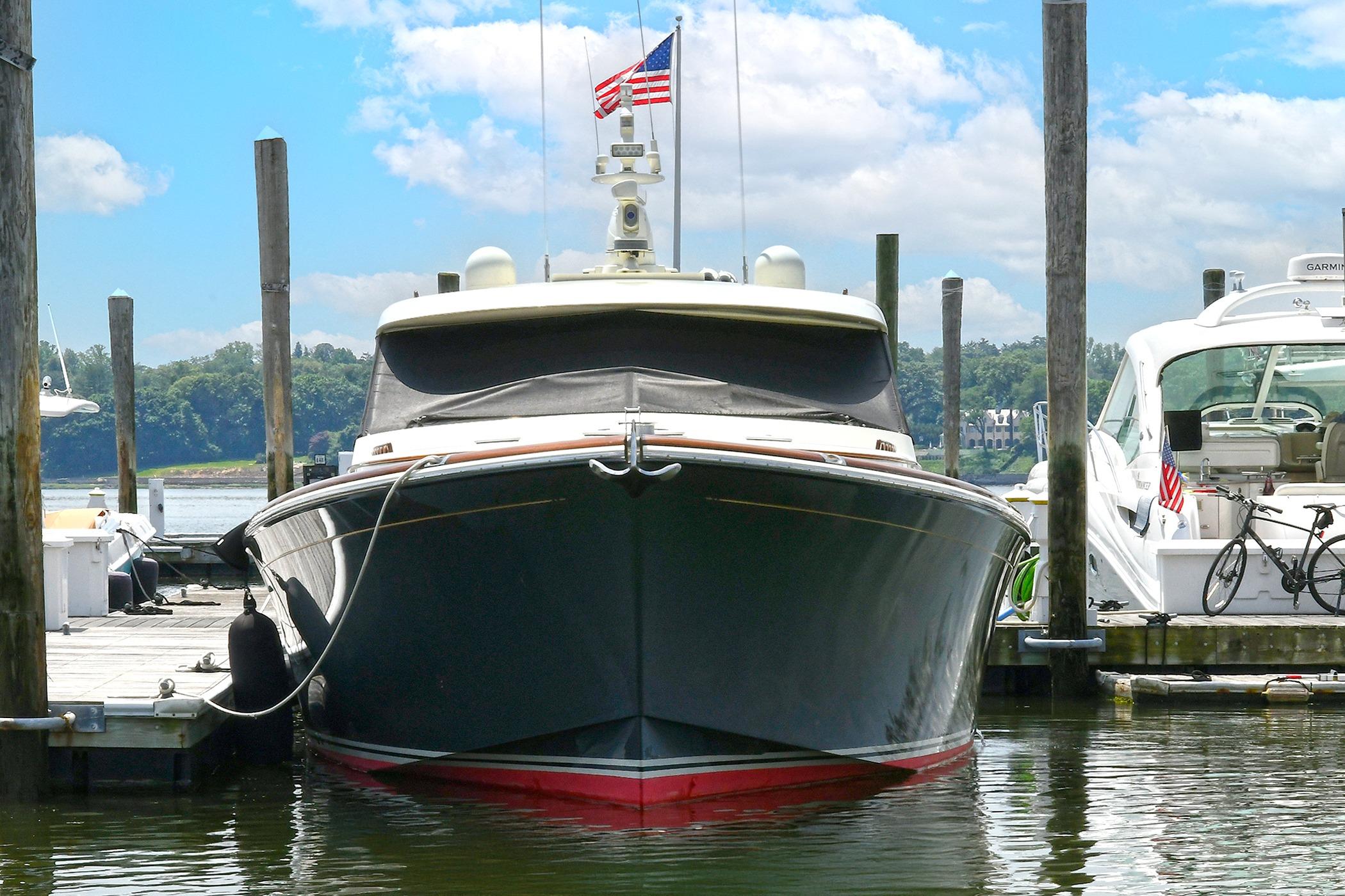 2005 San Juan Downeast Express yacht docked at marina with American flag.