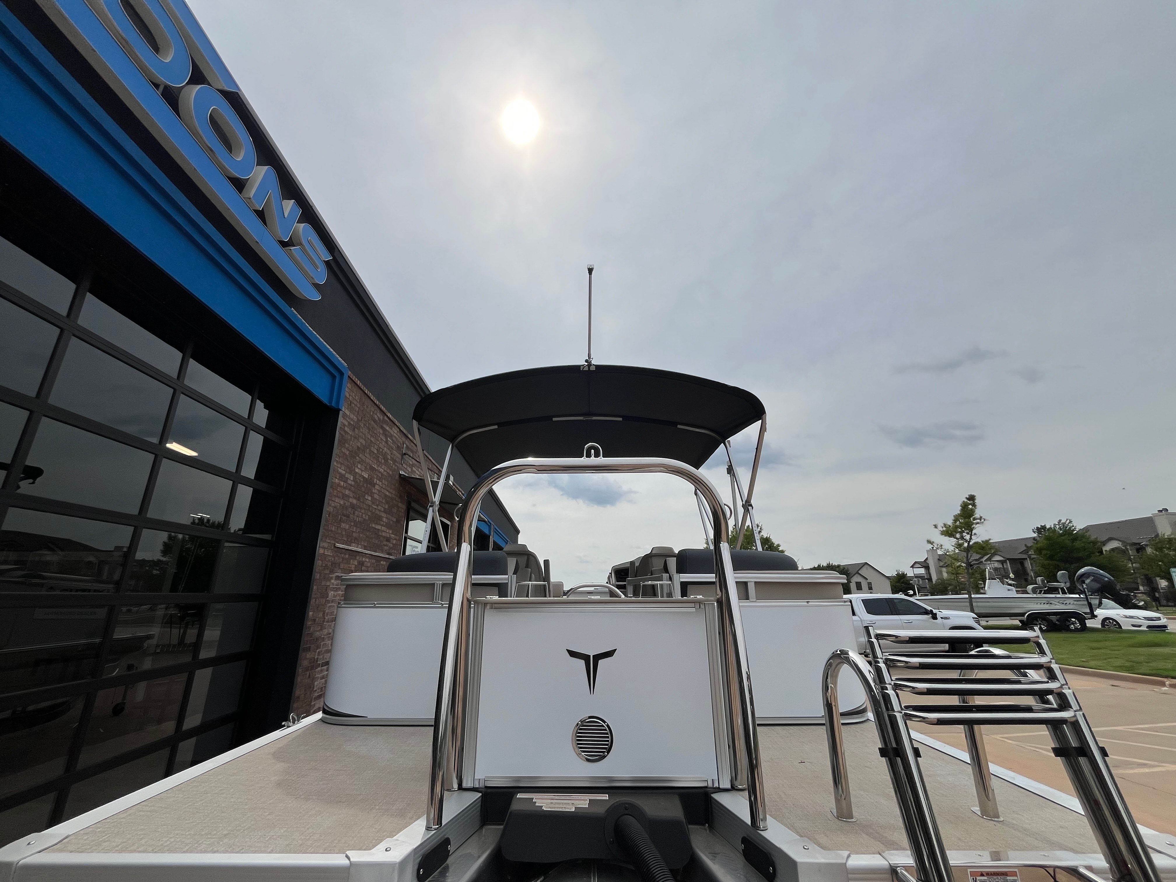 2025 Tahoe LTZ QL boat outside a building under sunny sky.