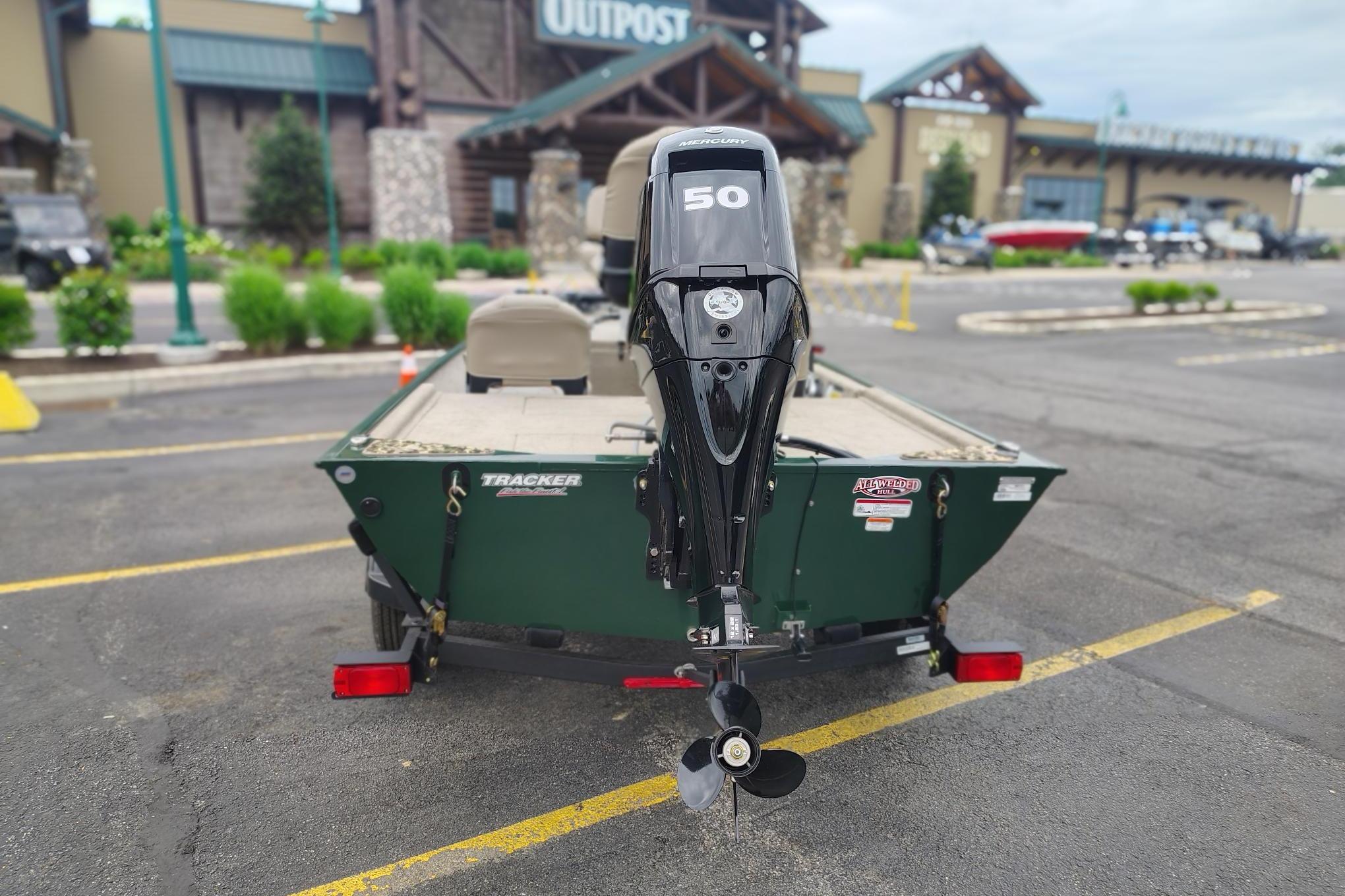 2026 Tracker Bass Tracker Classic Limited boat with Mercury 50 engine in parking lot.