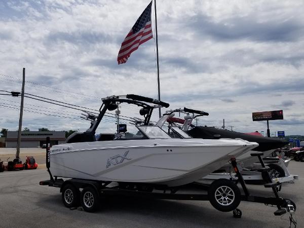 2023 ATX Surf Boats 20 Type-S on trailer, American flag in background.