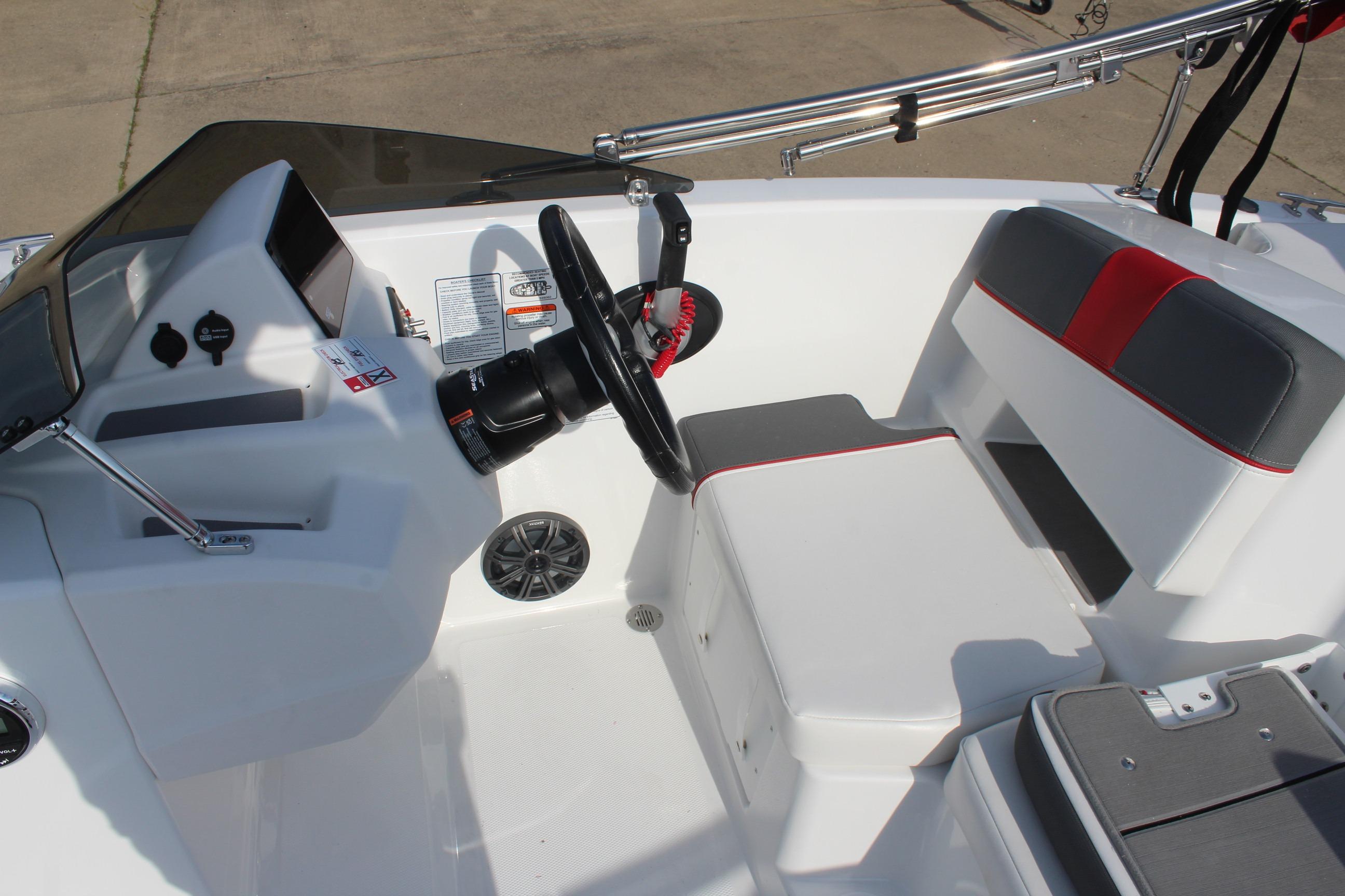 2026 Tahoe T18 boat interior with steering wheel and seating area.