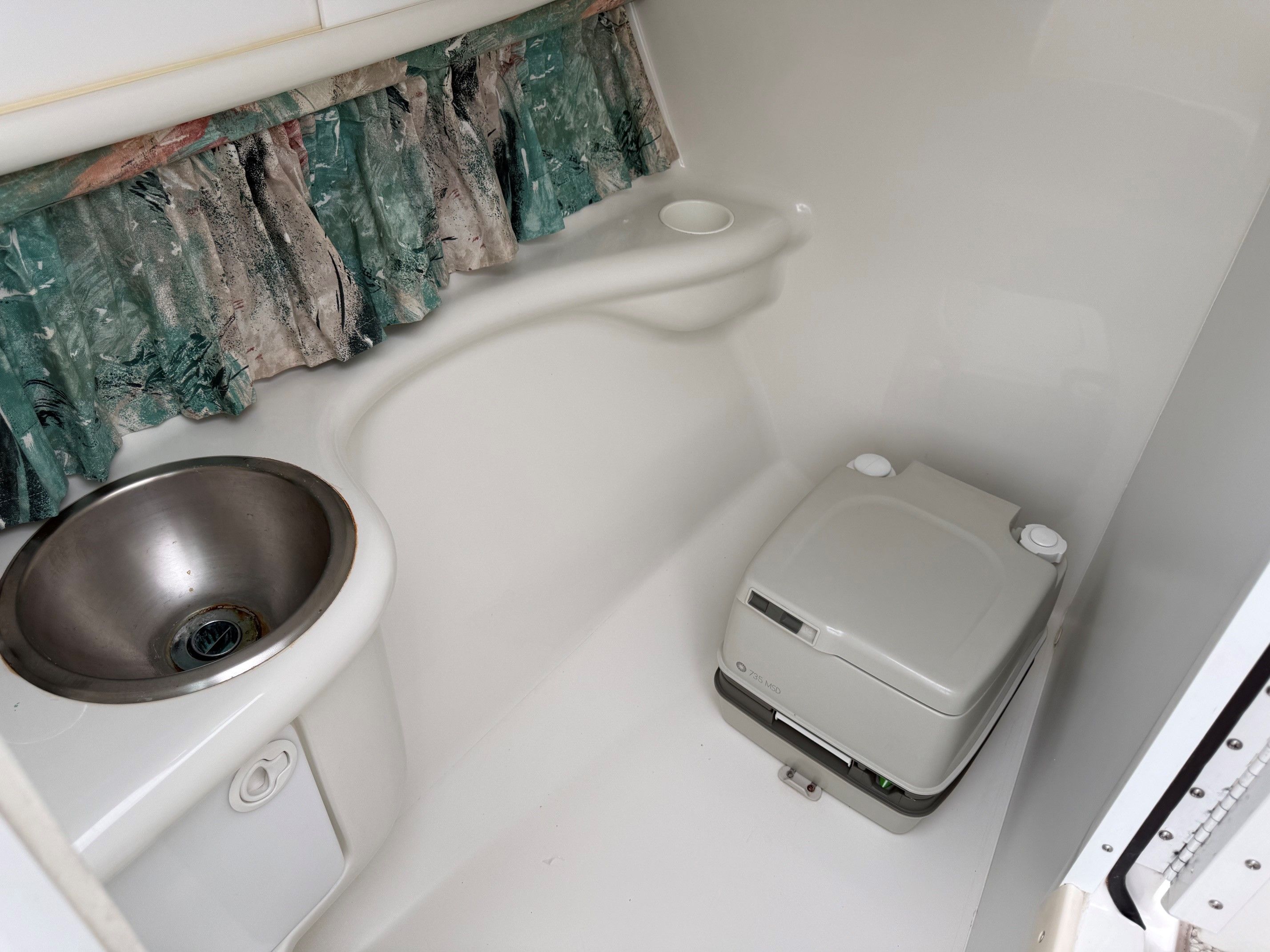 Interior of a 1998 Formula Thunderbird boat with sink and toilet.