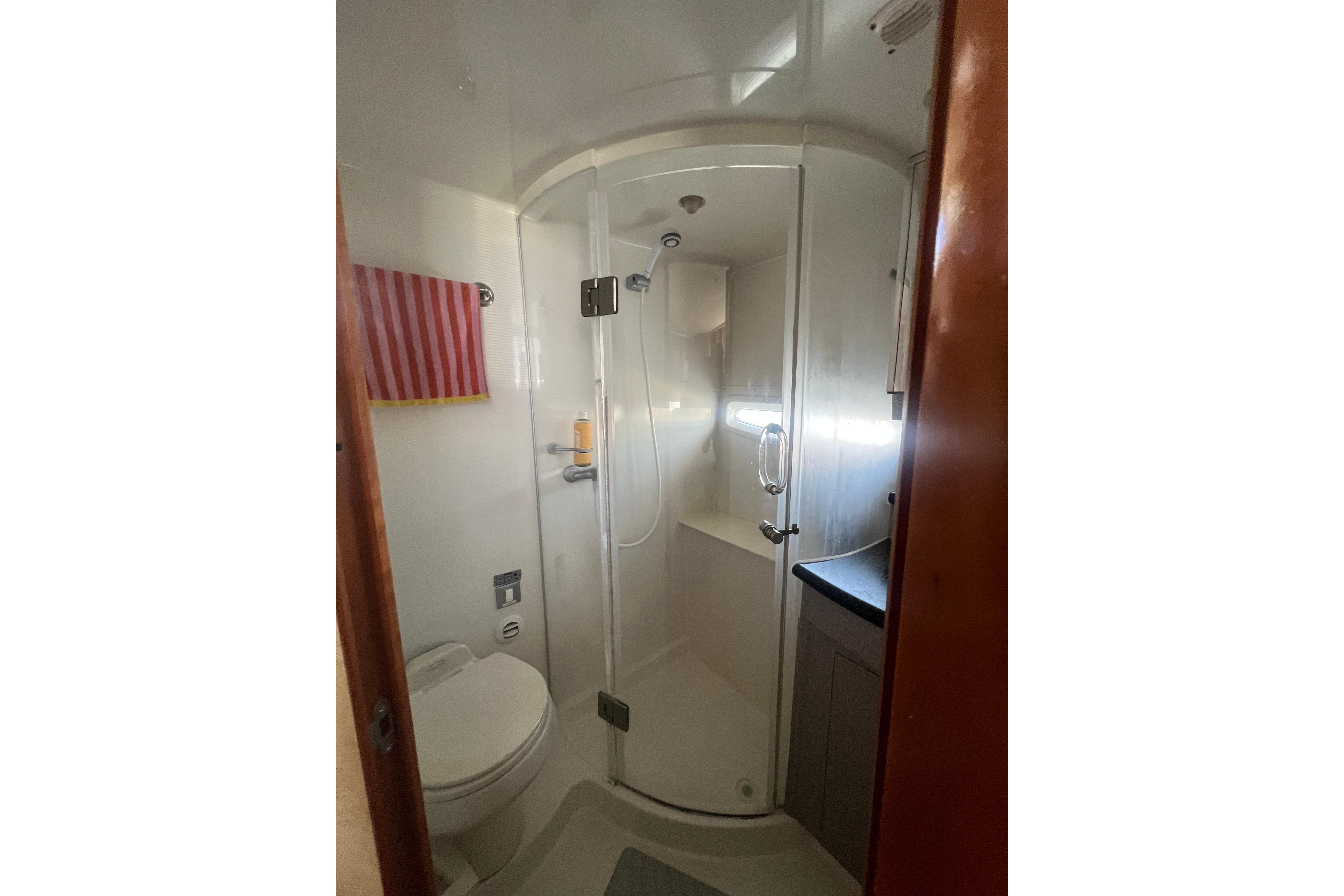 Bathroom interior of 2006 Carver 43 Motor Yacht with shower and toilet.