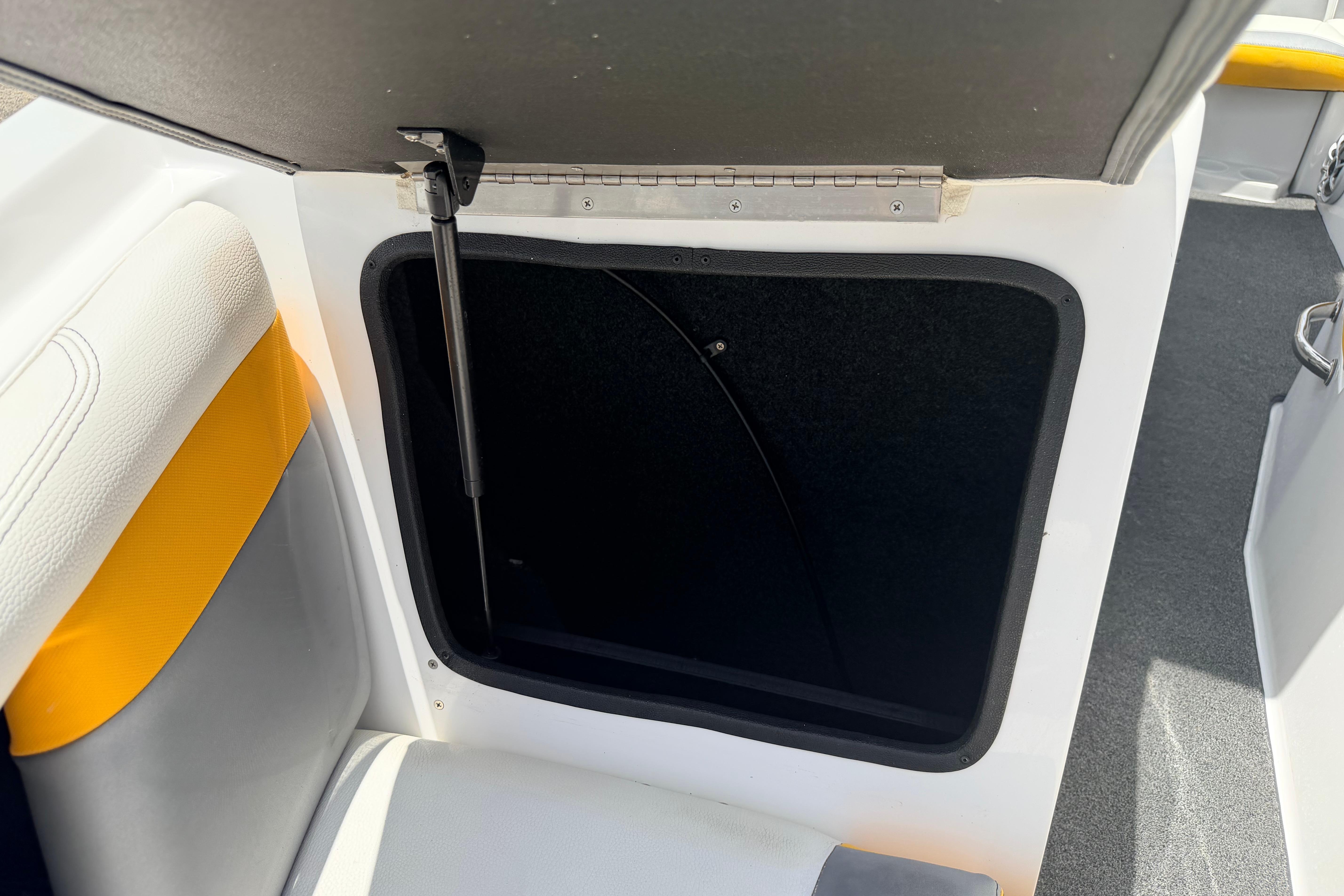 Open storage compartment in 2014 Tigé R20 boat interior.