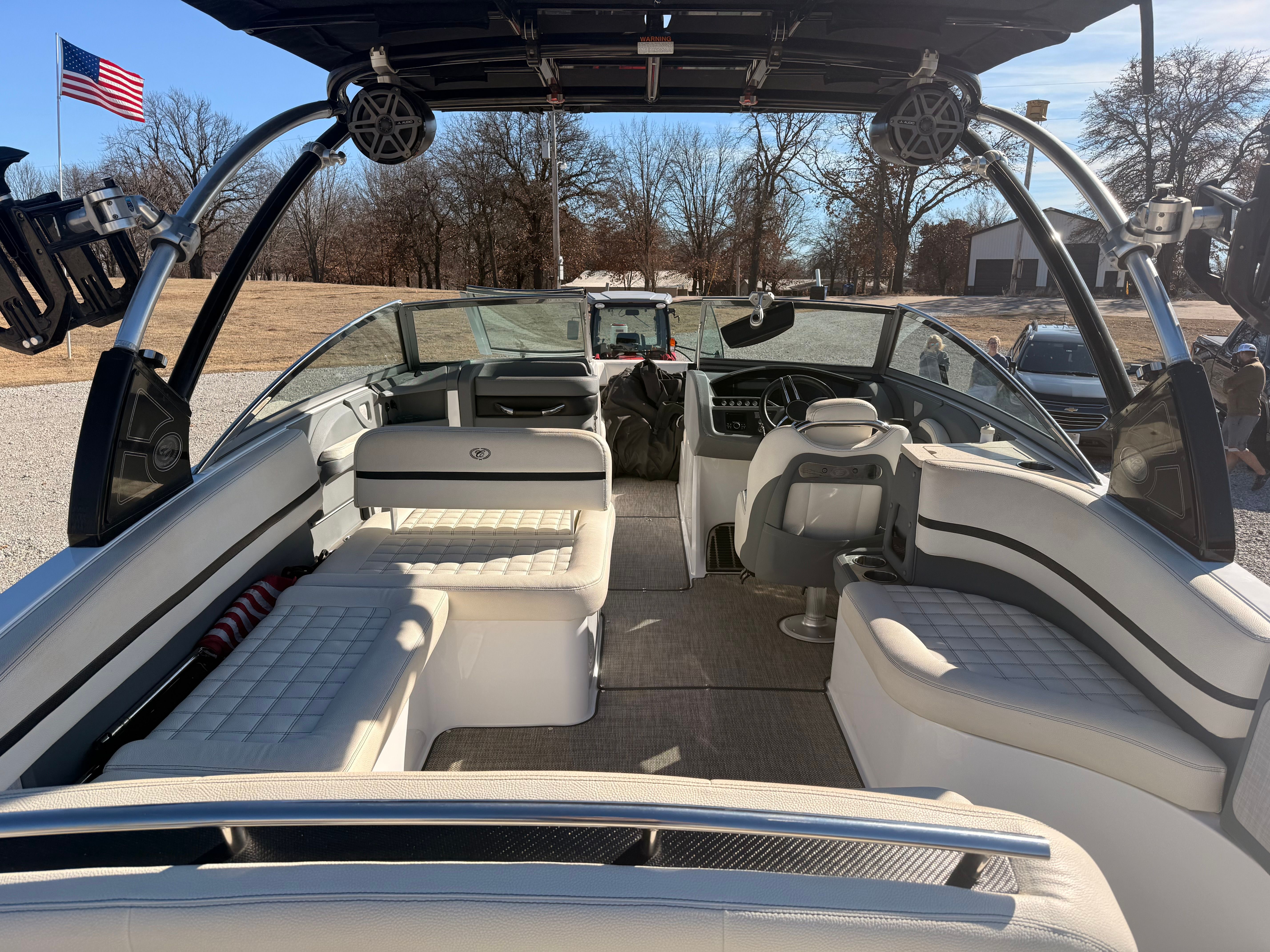 The image shows the interior of a 2019 Cobalt R7 Surf boat with white seating and a black canopy.
