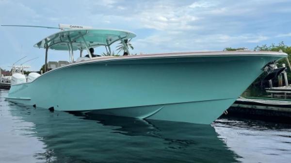 2025 Mag Bay 43 Center Console boat docked on calm water.