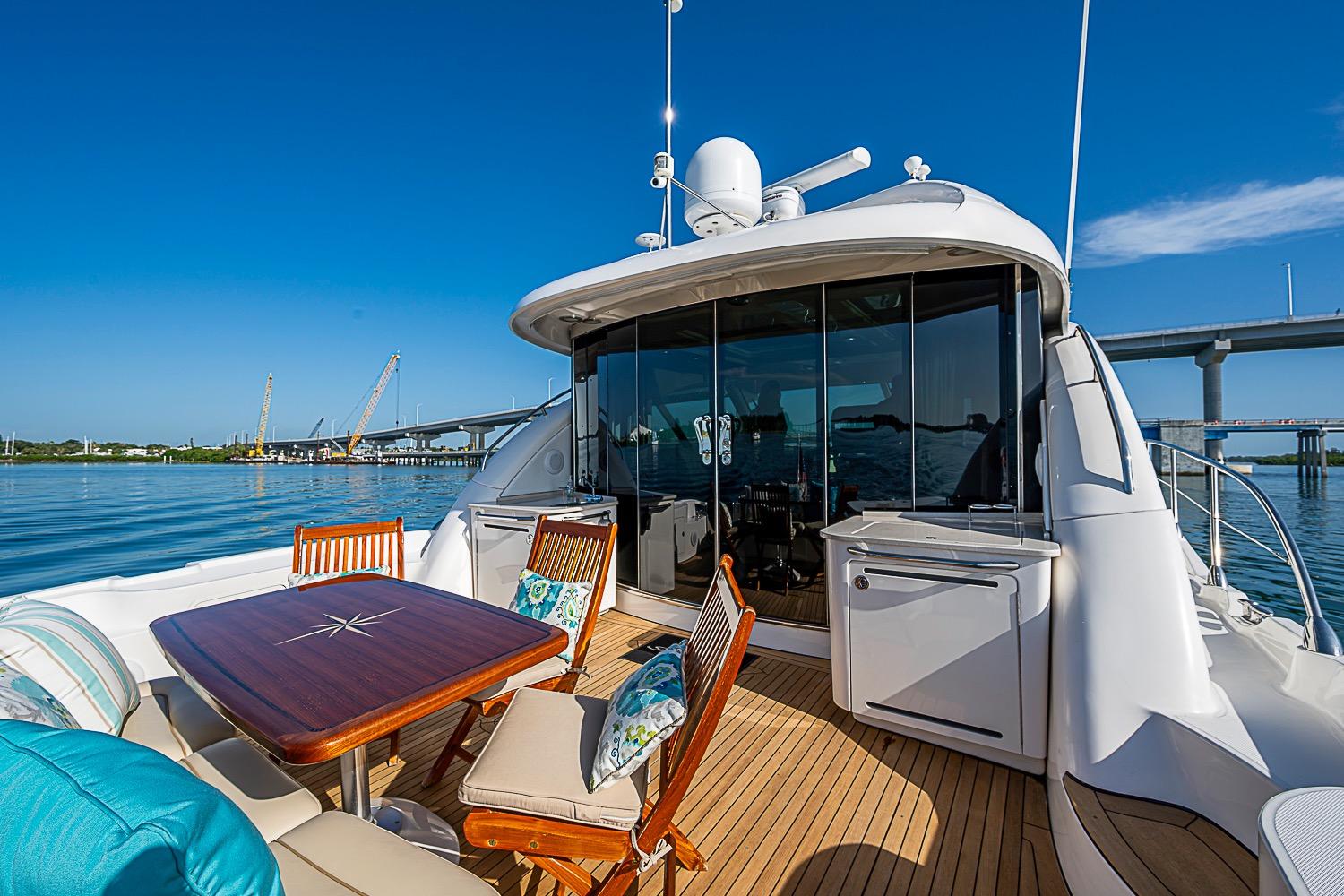 Luxurious 2008 Sea Ray 60 Sundancer yacht with elegant deck and scenic waterfront view.