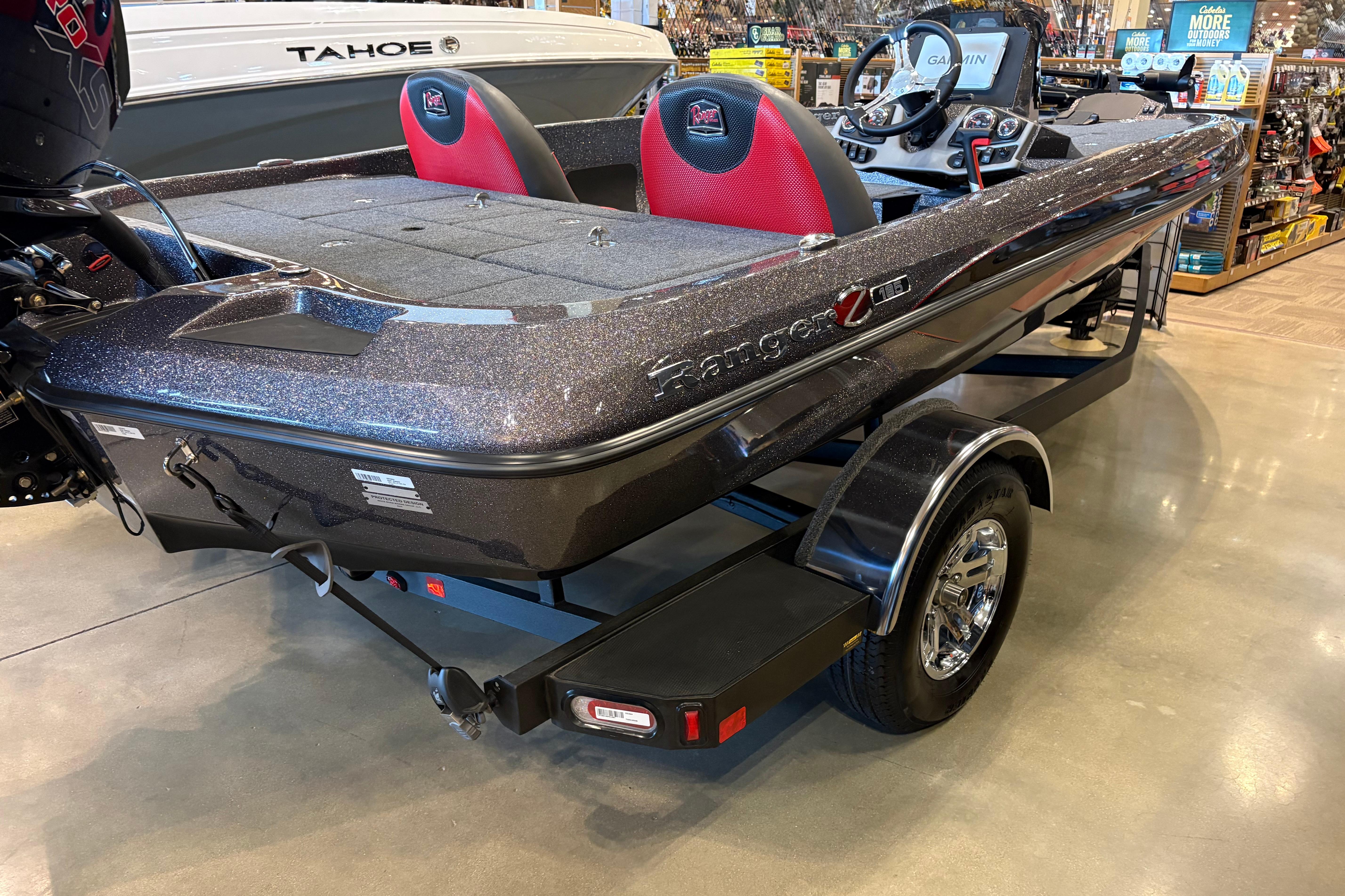 2025 Ranger Z185 boat with sleek design and red seats on display indoors.