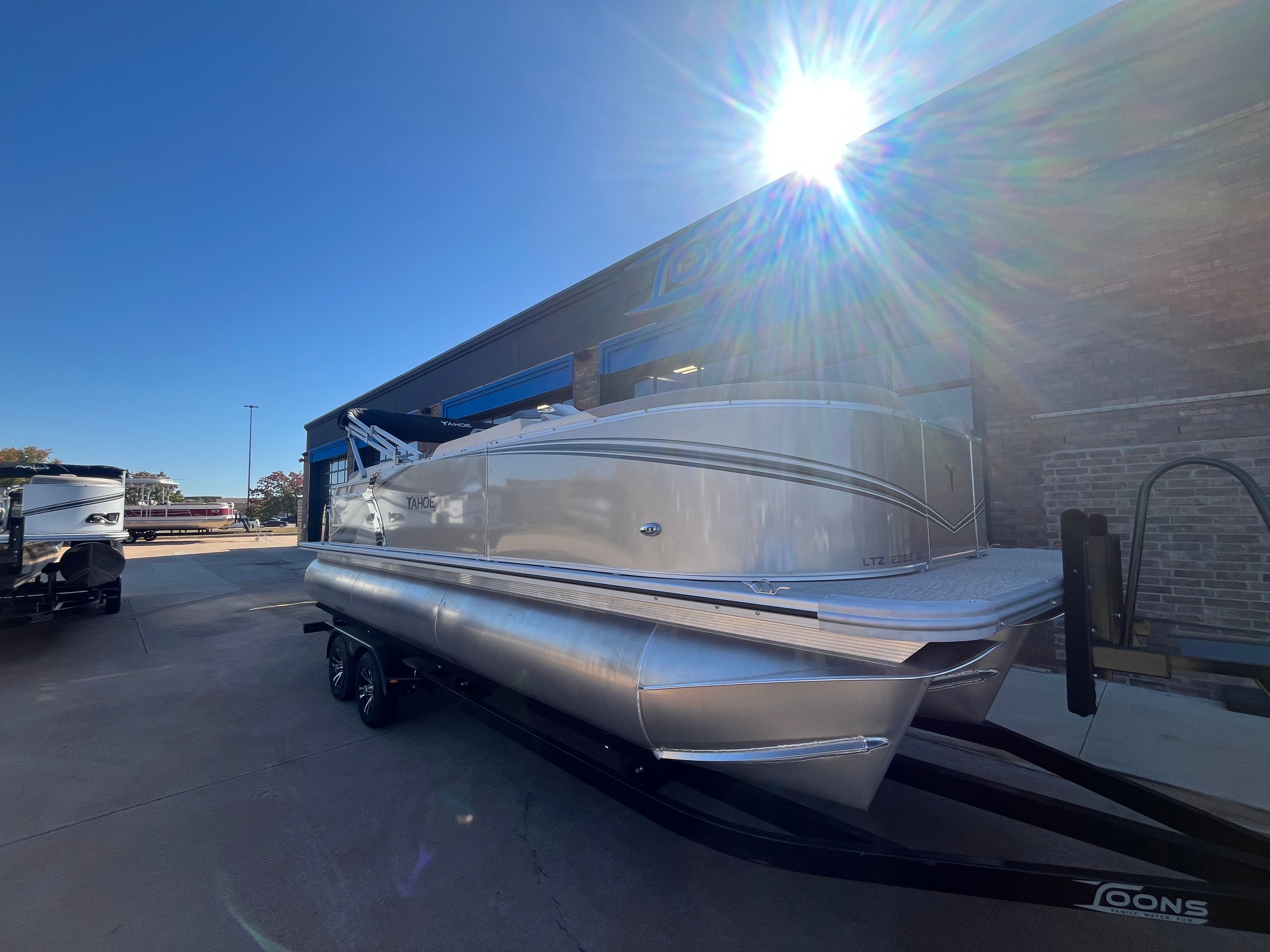 2026 Tahoe 2385 LTZ Quad Lounger pontoon boat in sunlight.