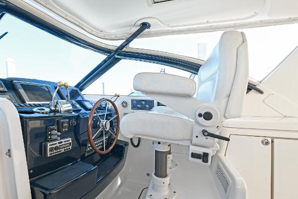 2008 Tiara Yachts 4200 Open helm with white captain's chair and wooden steering wheel.