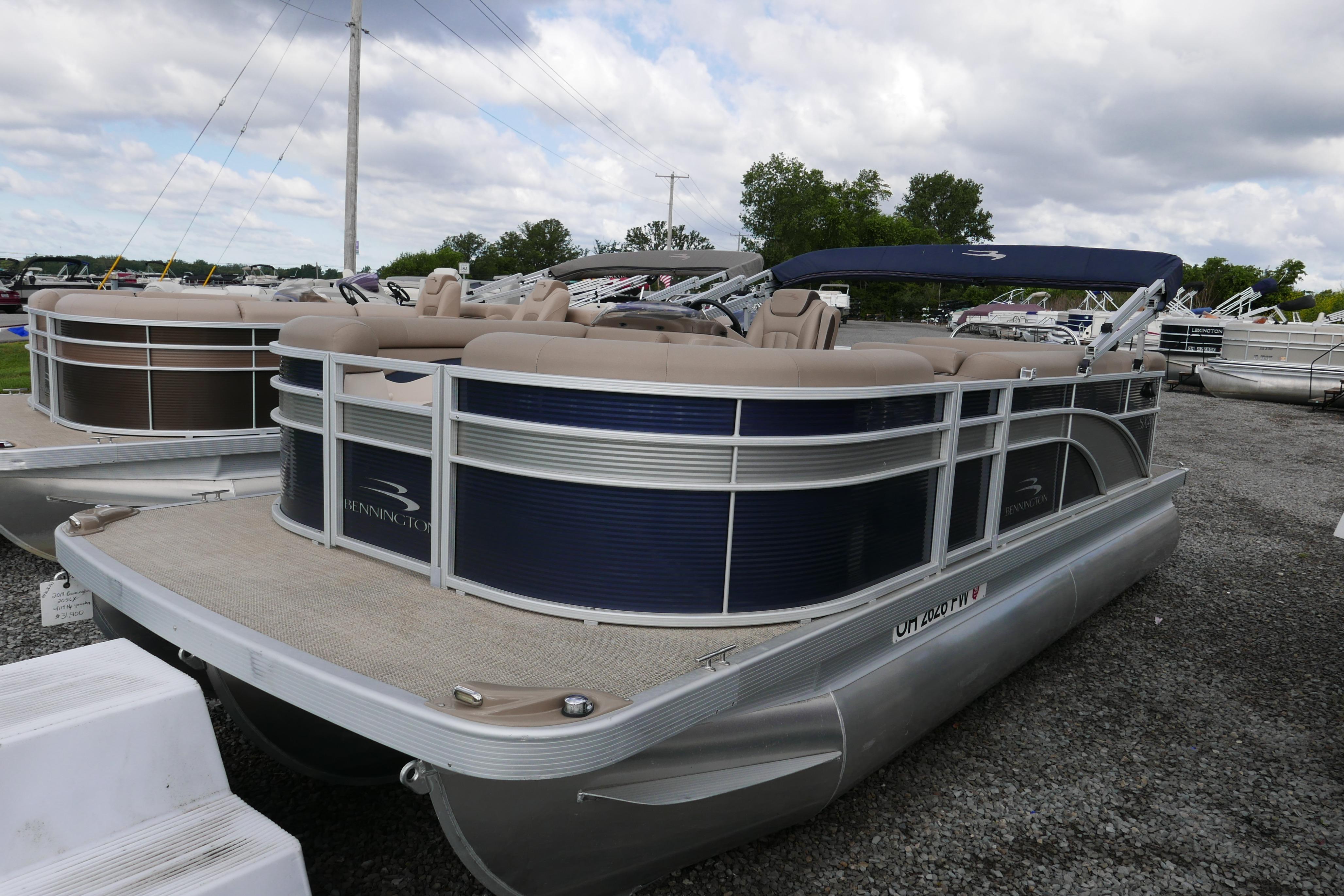 2019 Bennington SX 20 SLXP pontoon boat with blue and beige design, parked outdoors.