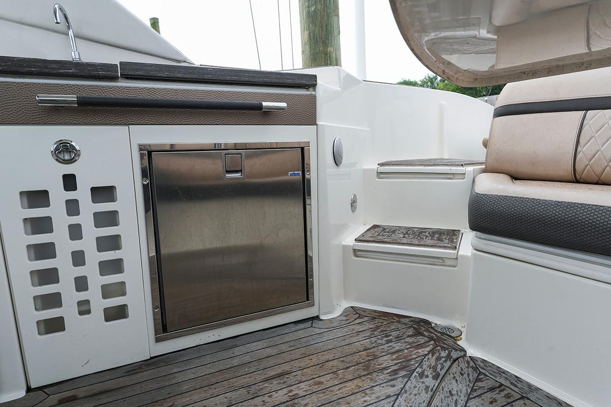 2018 Sea Ray SLX 350 boat interior with kitchenette and seating area.