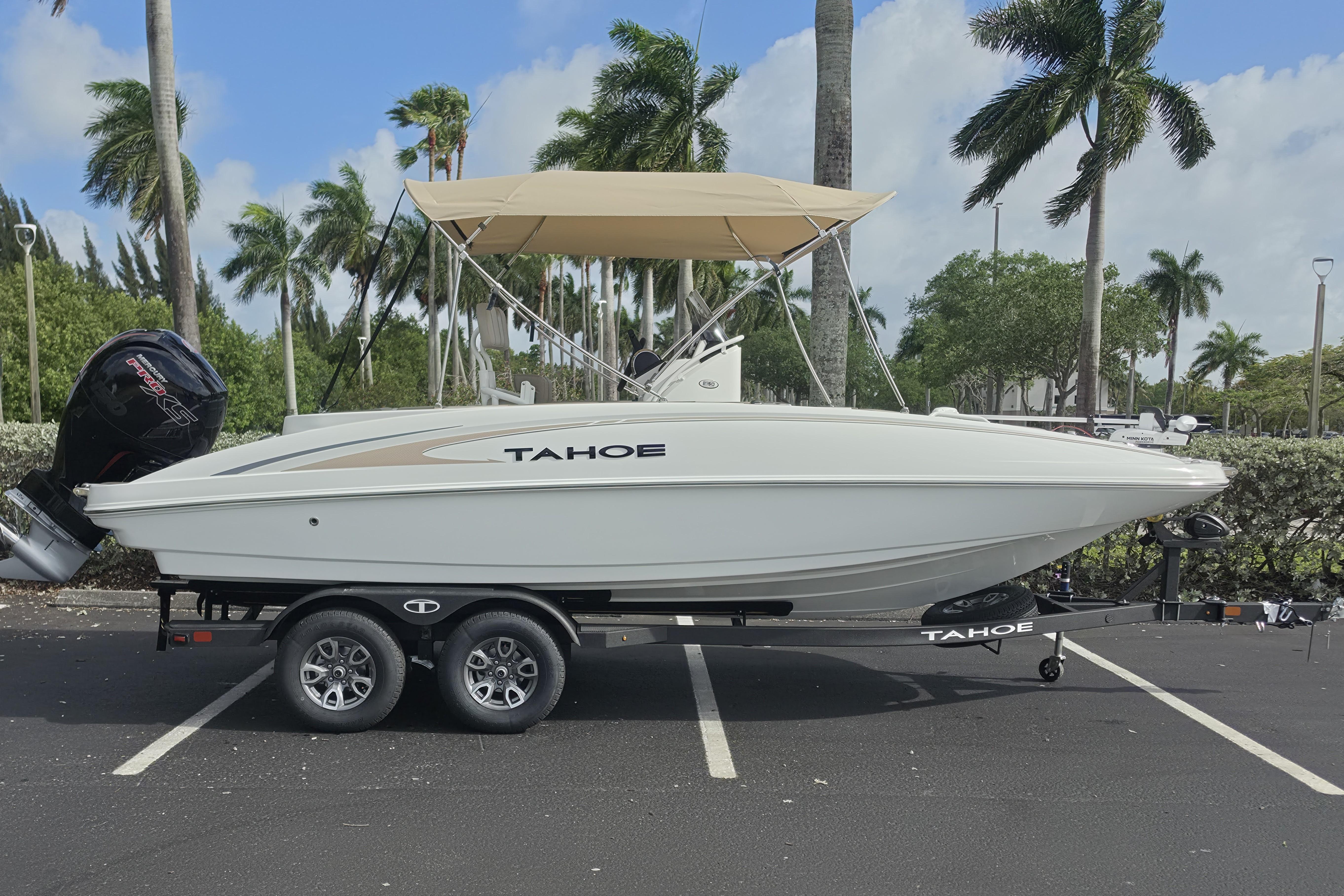 2026 Tahoe 2150 CC boat on trailer, parked with palm trees in background.
