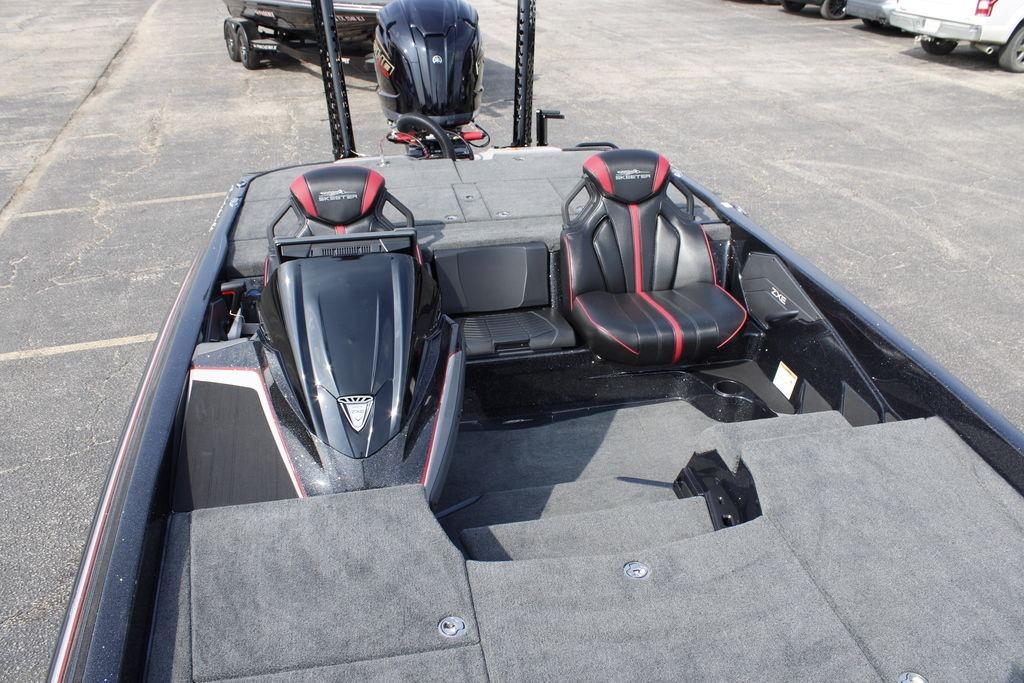2026 Skeeter ZXE21 boat interior with black and red seats, parked on pavement.
